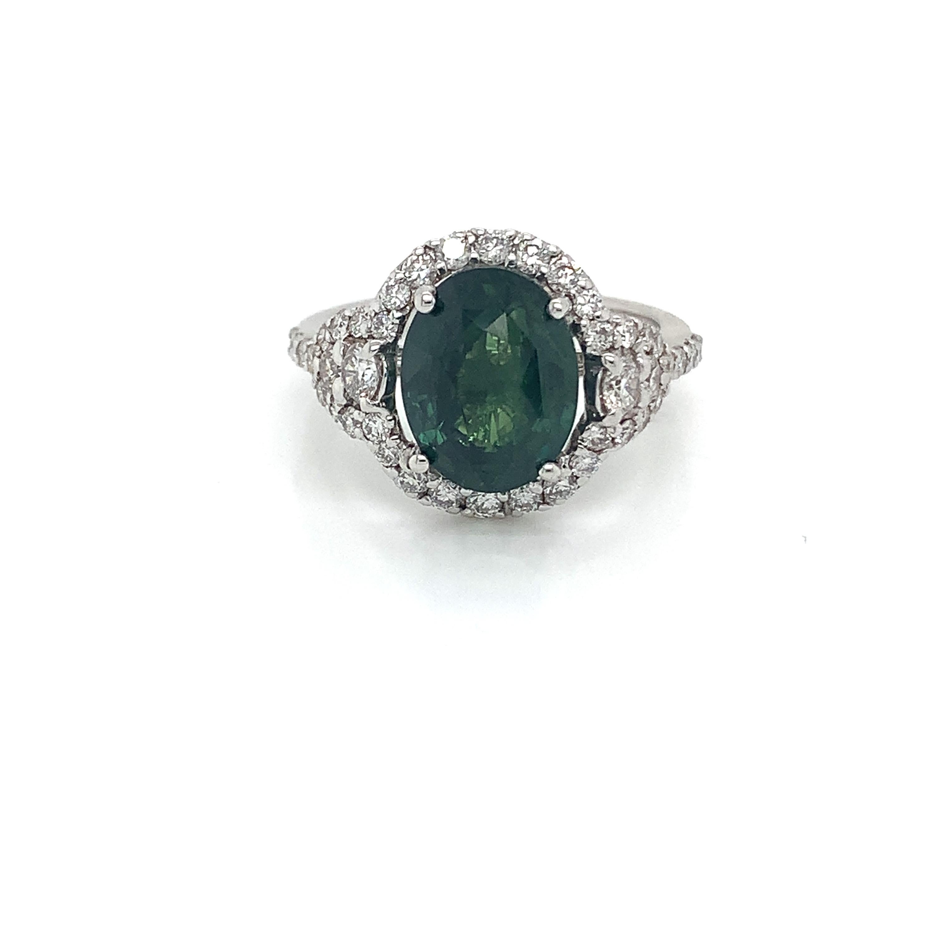 Oval green sapphire weighing 4.69 cts.
Measuring (10.7x8.3) mm
42  pieces of diamonds weighing .98 cts.
Set in 18K white gold ring