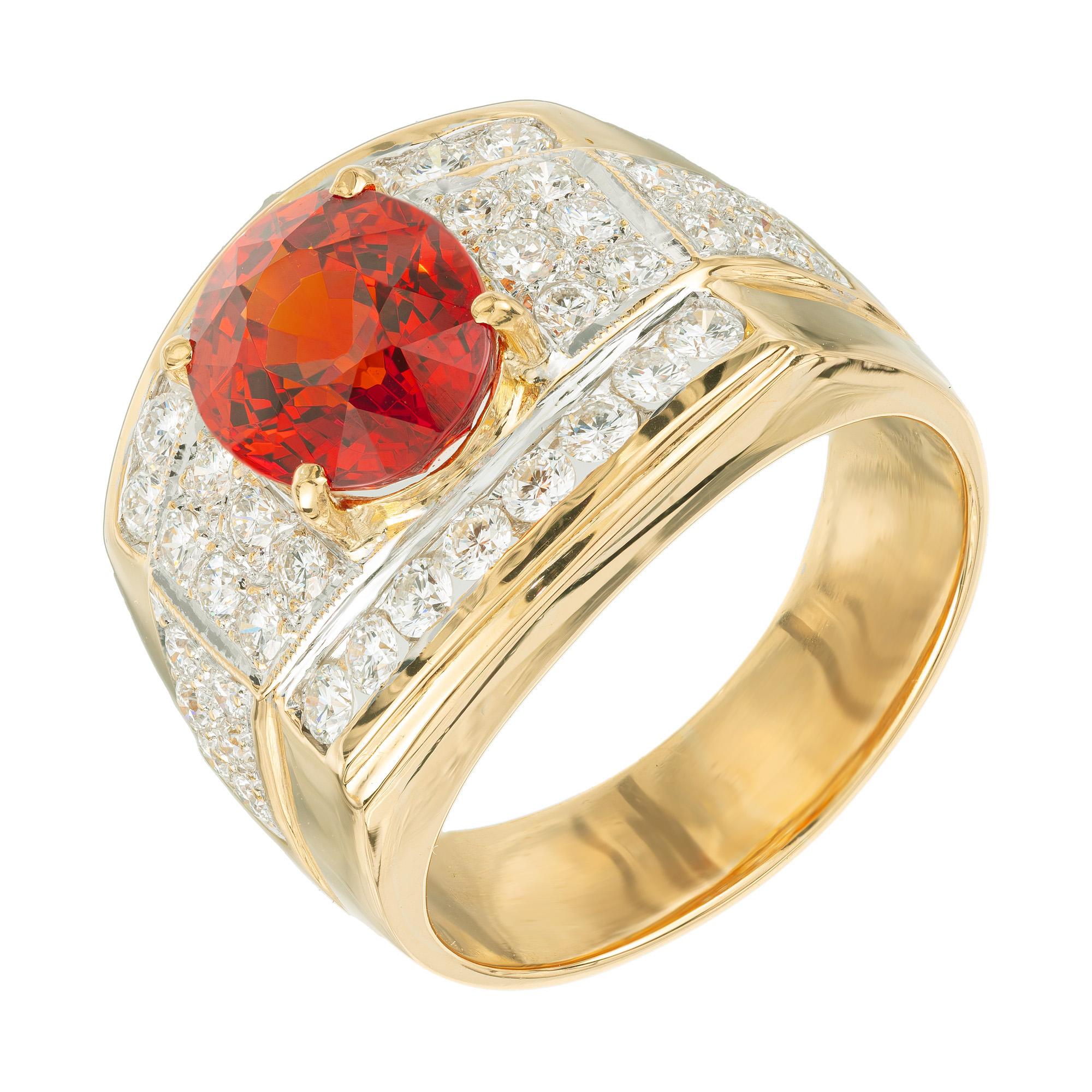 1980's Hessonite garnet and diamond ring. Set with a rich orange oval 4.69ct hessonite mounted in a beautifully made 22k yellow and white gold setting. The center stone has fiery mix of orange and red hues and is surrounded by 24 round brilliant cut