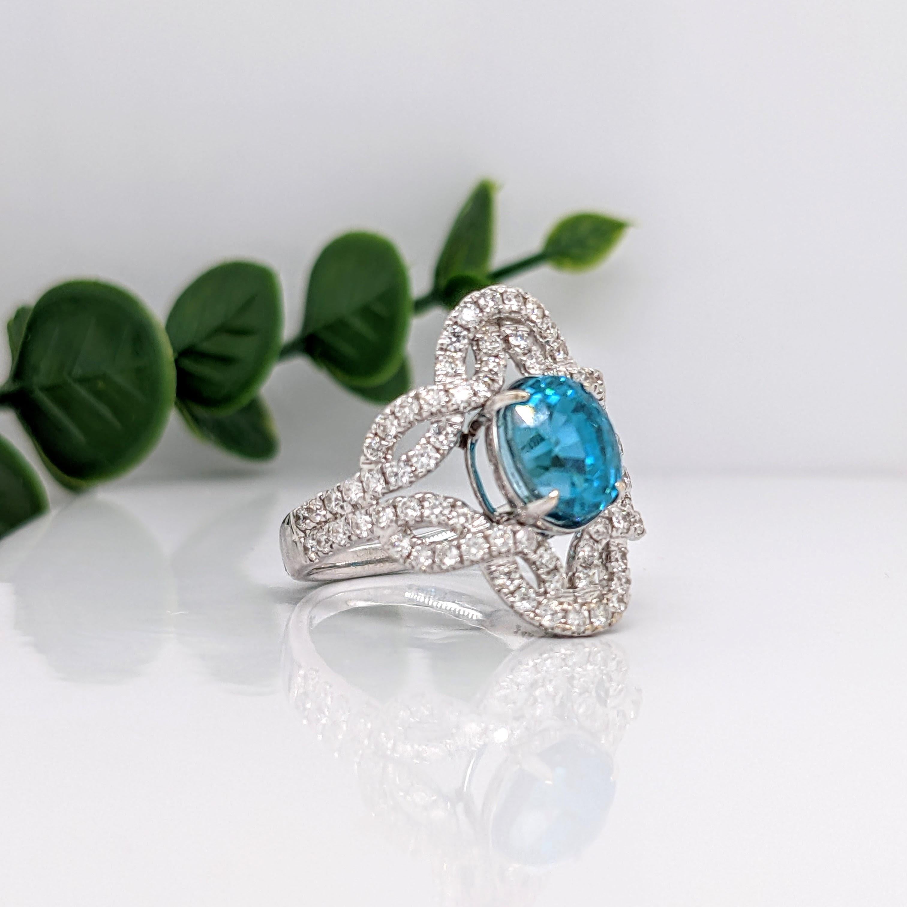 This embellished ring features a celtic knot inspired ring with a stunning 4.6 carat vibrant blue zircon in 14K white gold with natural earth mined diamonds. This unique ring makes for a stunning accessory to any look!

A fancy ring design perfect