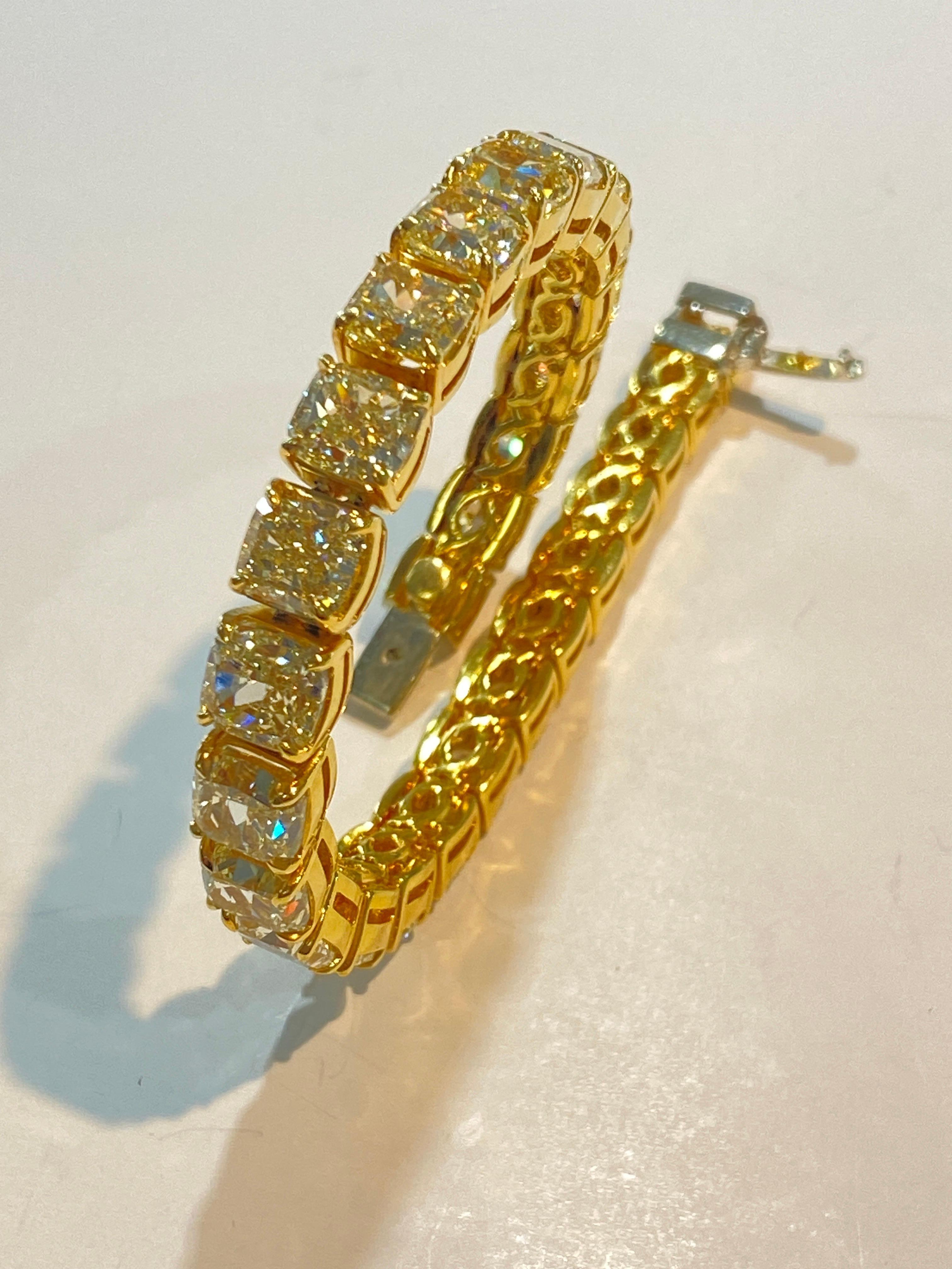18 Karat gold, fancy yellow diamond bracelet consisting of twenty-eight cushion cut diamonds set in a four-prong, yellow gold setting. The bracelet measures a height of 6.62 inches. The length is 7.13 inches. The total weight of the diamonds is
