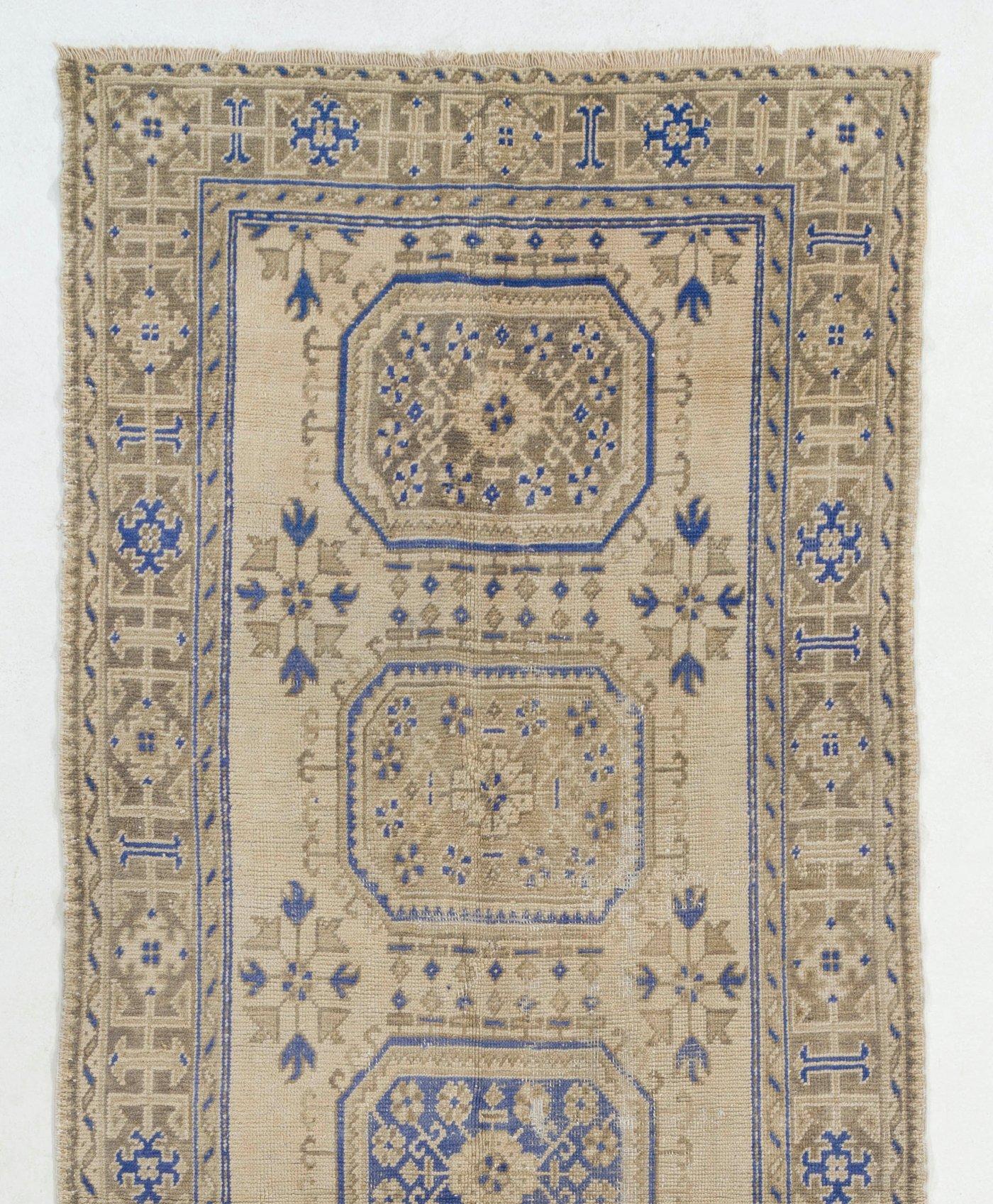 A gorgeous vintage Turkish runner rug, hand-knotted with even medium wool pile on wool foundation. It features geometric medallions decorated with floral motifs. It is in good condition, professionally-washed and sturdy. Measure: 4.6x12.2 Ft.