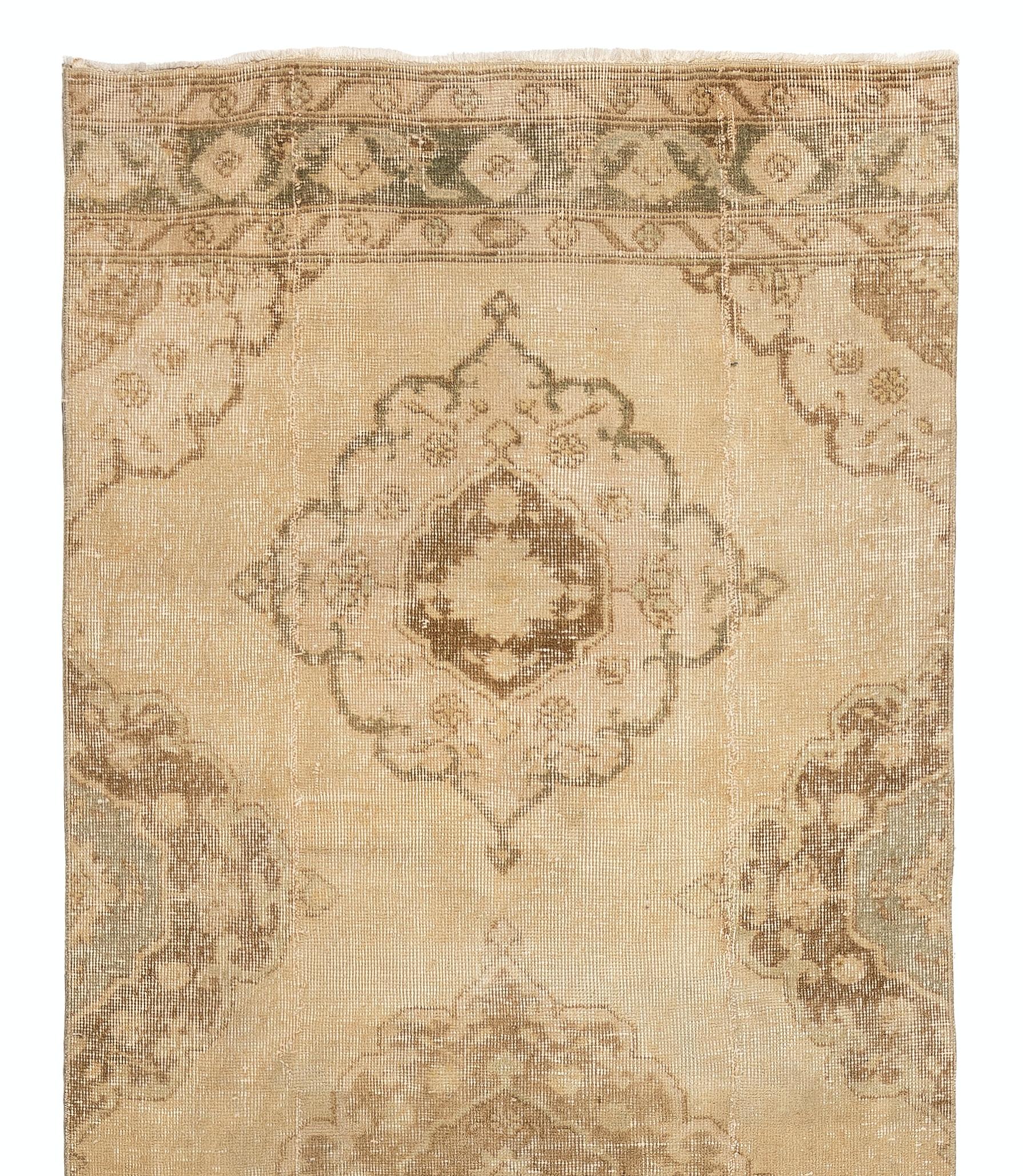 A vintage Turkish runner rug featuring multiple curvilinear medallions in mocha brown, fawn and grayish green colors across the length of its golden sand field and borders decorated with floral heads at its top and bottom ends. 

This runner rug was