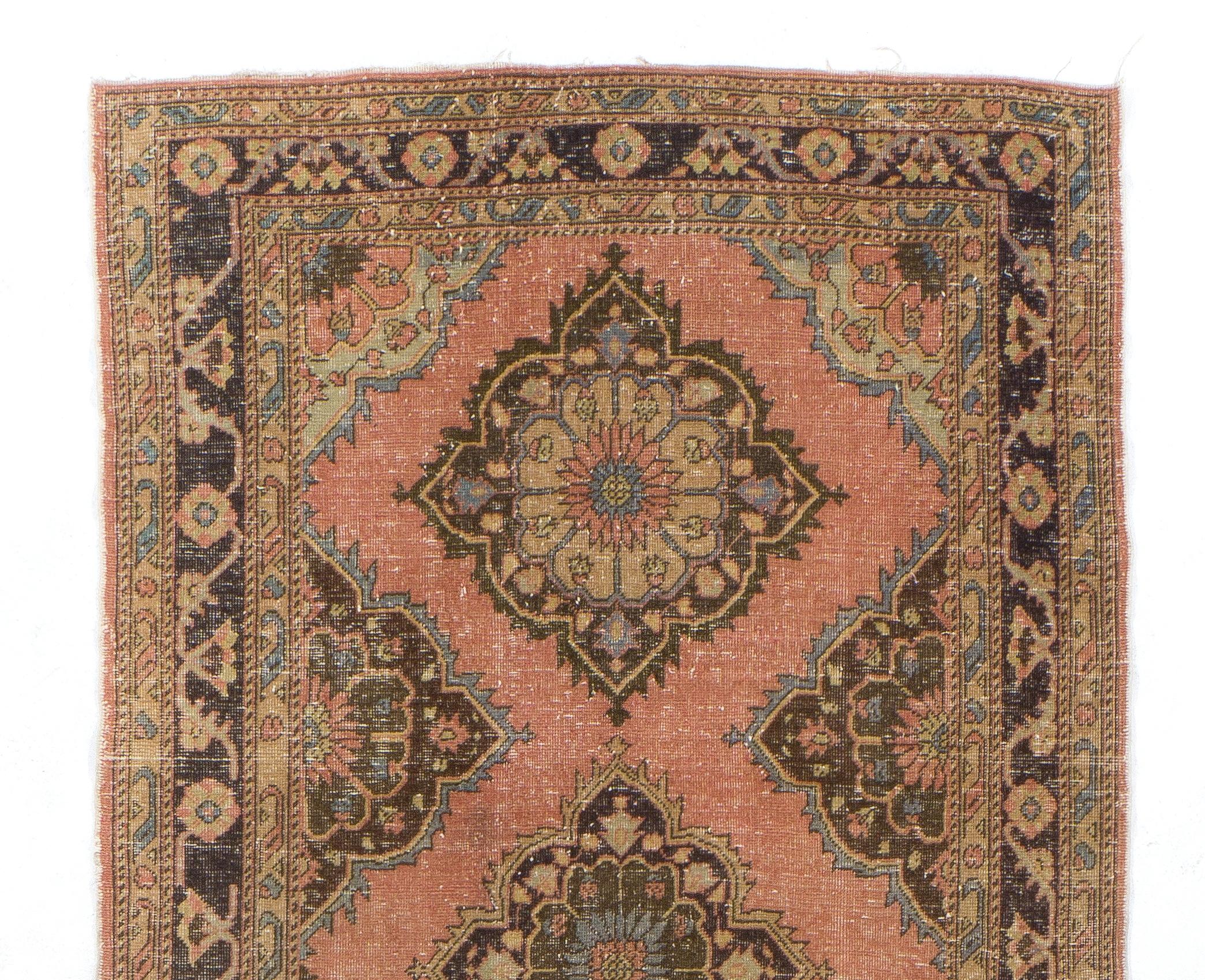 A vintage Turkish runner rug featuring a multiple medallion design.
The rug was hand-knotted in the 1960s and has low wool pile on cotton foundation. It is in very good condition, professionally-washed, sturdy and suitable for areas with high foot