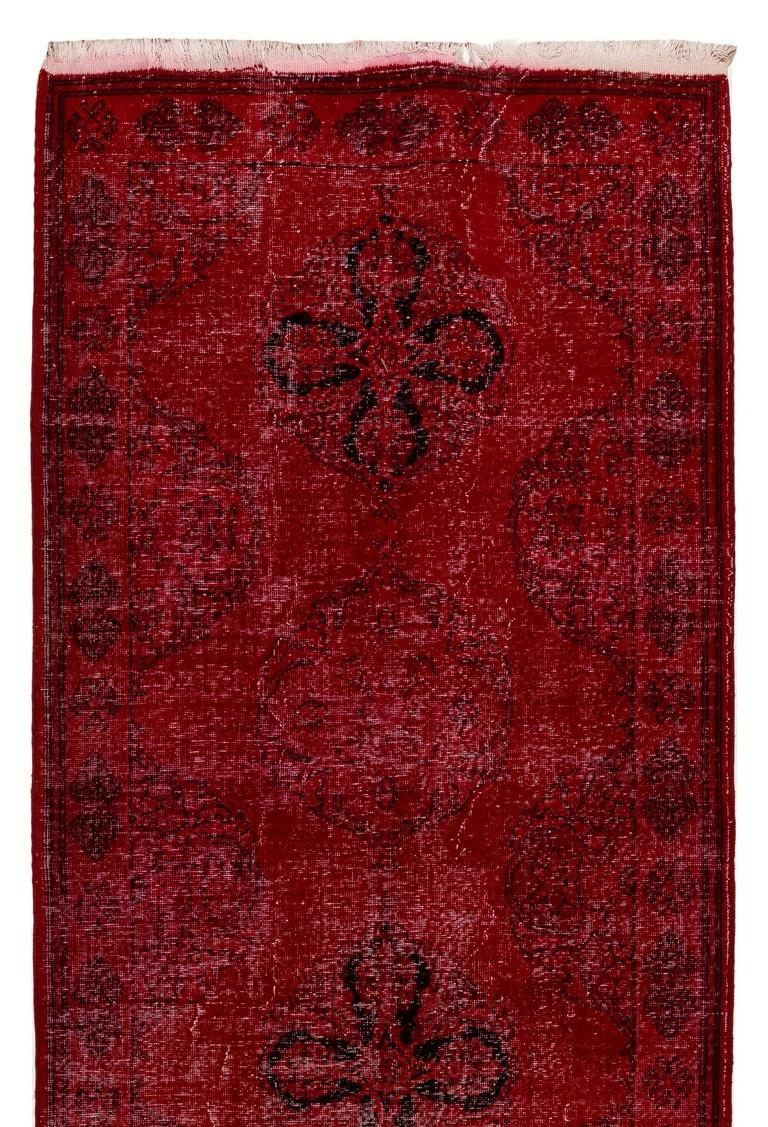 A vintage Turkish runner rug re-dyed in red color, great for contemporary interiors.
Finely hand knotted, low wool pile on cotton foundation. Professionally washed.
Sturdy and can be used on a high traffic area, suitable for both residential and