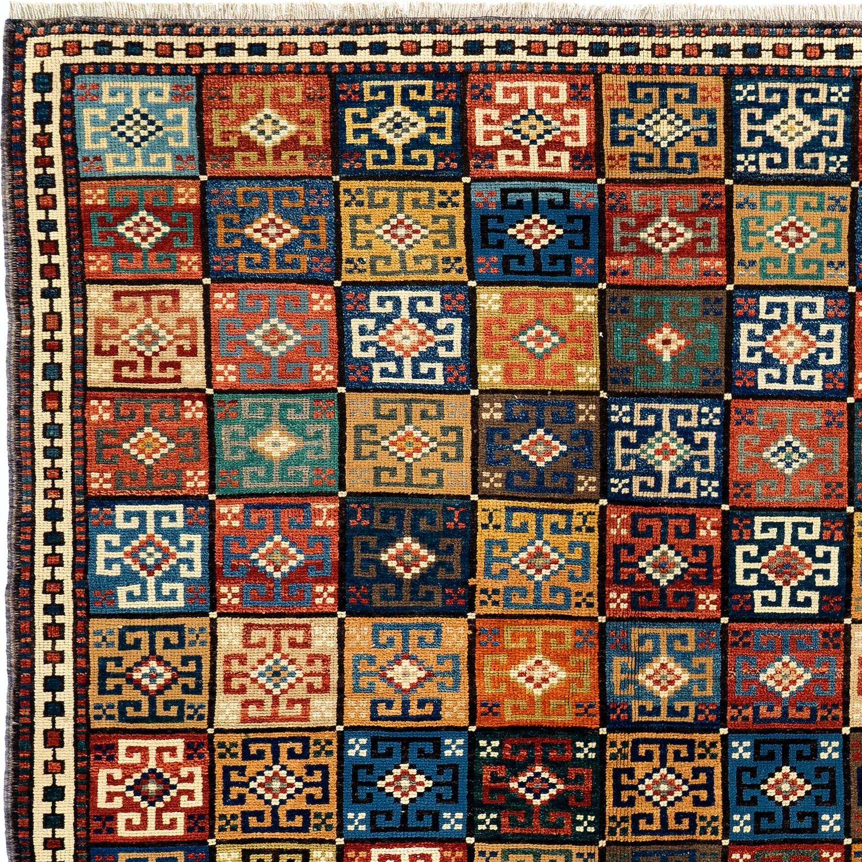 A colorful hand-knotted rug from Turkey with an unusual all-over design of 96 square boxes with flowers in them. Size: 4.7 x 5.8 Ft.
Made of 100% flower, root and plant dyed hand-spun wool.

In excellent condition with even medium pile