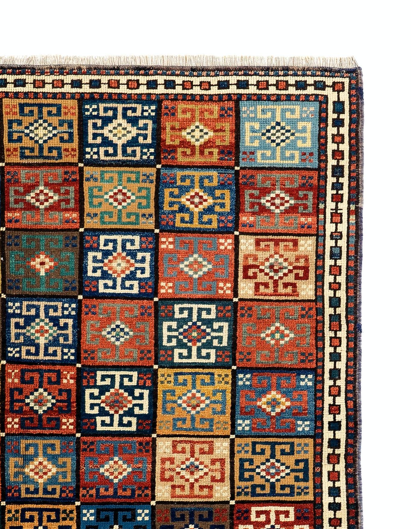 A colorful hand-knotted rug from Turkey with an unusual all-over design of 96 square boxes with flowers in them. Size: 4.7 x 5.8 Ft.
Made of 100% flower, root and plant dyed hand-spun wool.

In excellent condition with even medium pile