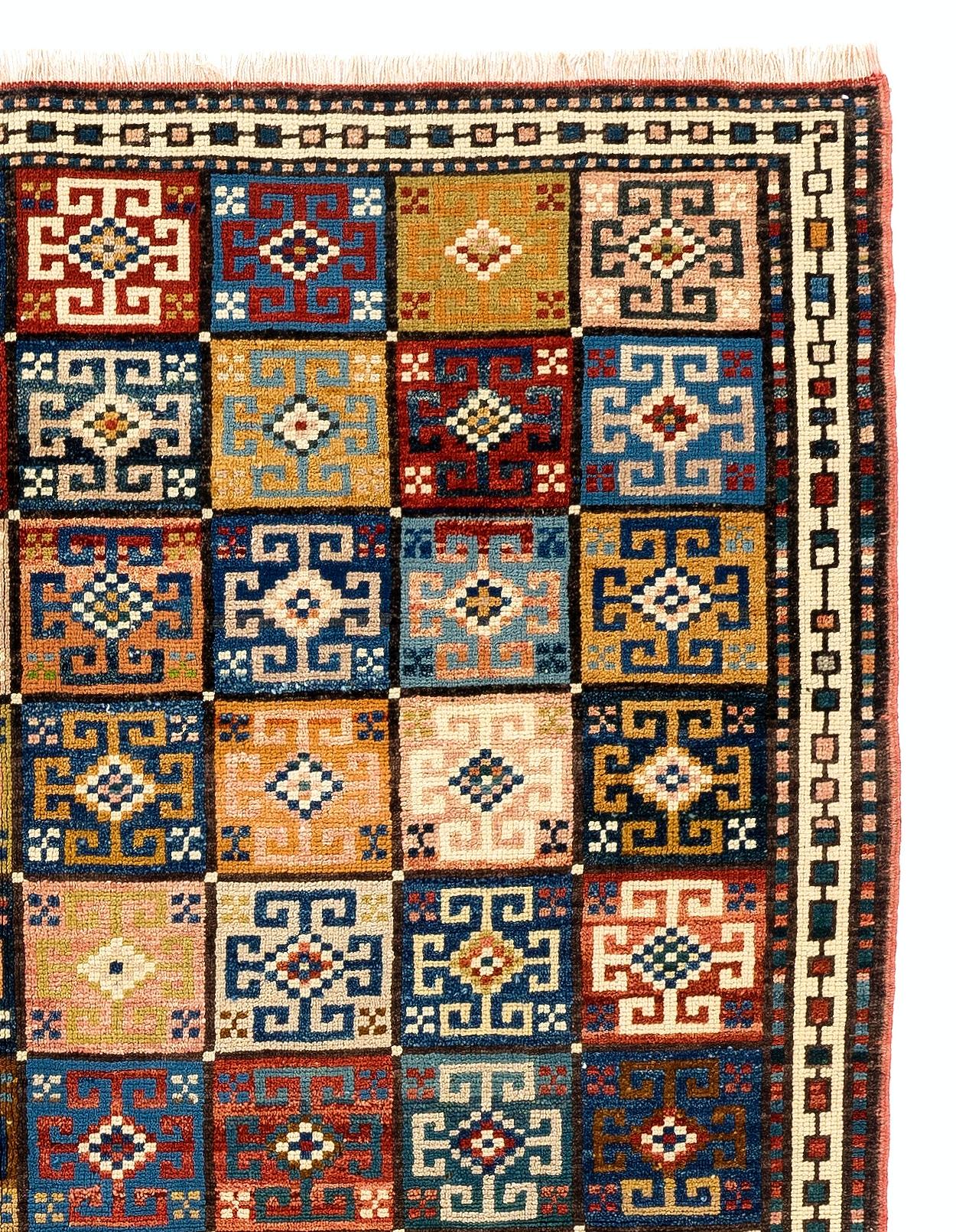 A colorful hand-knotted rug from Central Anatolia with an unusual all-over design of 96 square boxes with flowers in them. Measures: 4.6 x 5.9 ft.
Made of 100% flower, root and plant dyed hand-spun wool.
Excellent condition with even medium pile