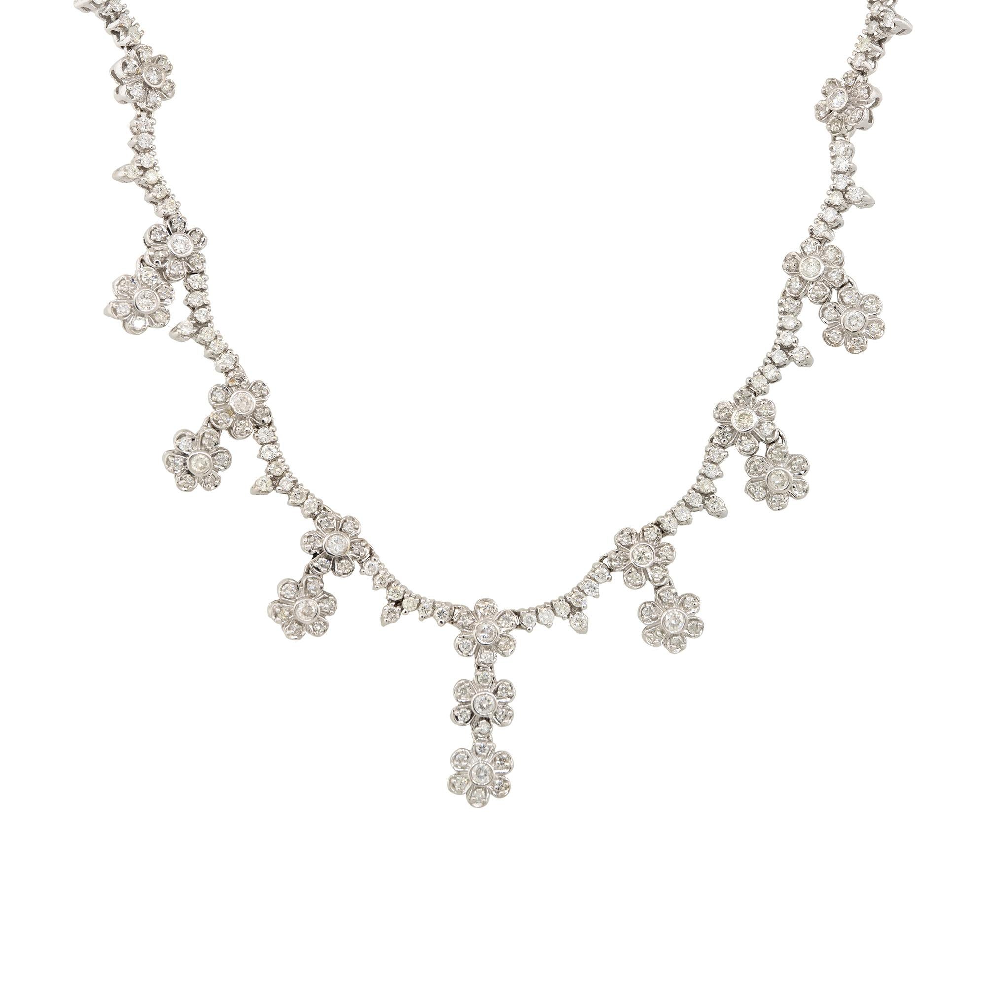 This multi-flower diamond drop necklace is the perfect piece of jewelry for someone who loves flowers and diamonds! This necklace is set using round brilliant cut diamonds and the way they are set gives off a scalloped look. This necklace offers a