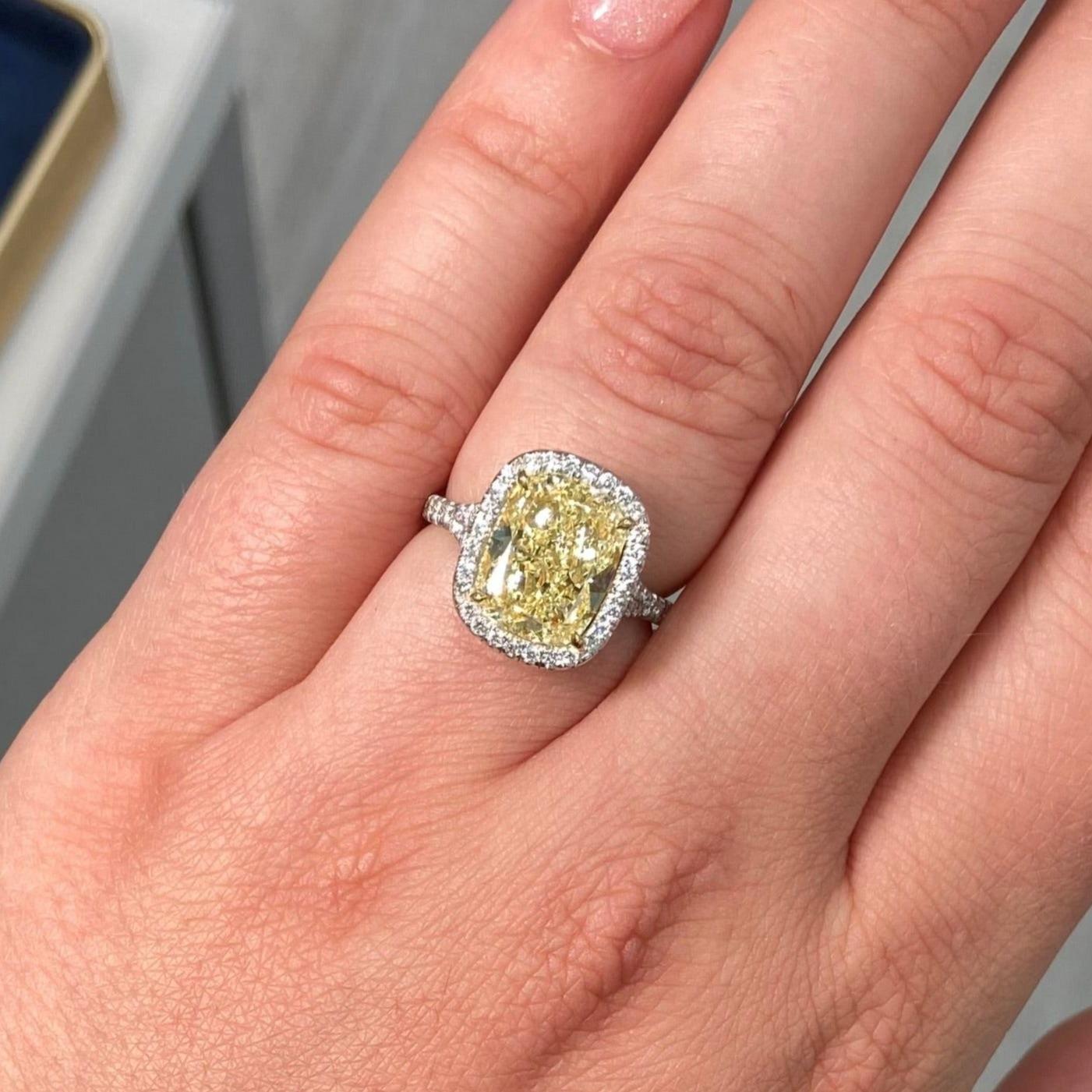 4.73 Carat Center Diamond
GIA Light Yellow
VS2 Clarity 
Cushion Cut Diamond 
0.52 Carats of White Rounds 
Set in Platinum and 18k Gold 
Split Shank band 
Handmade in NYC
GIA Certified Diamond 


This piece can be viewed before purchase in our