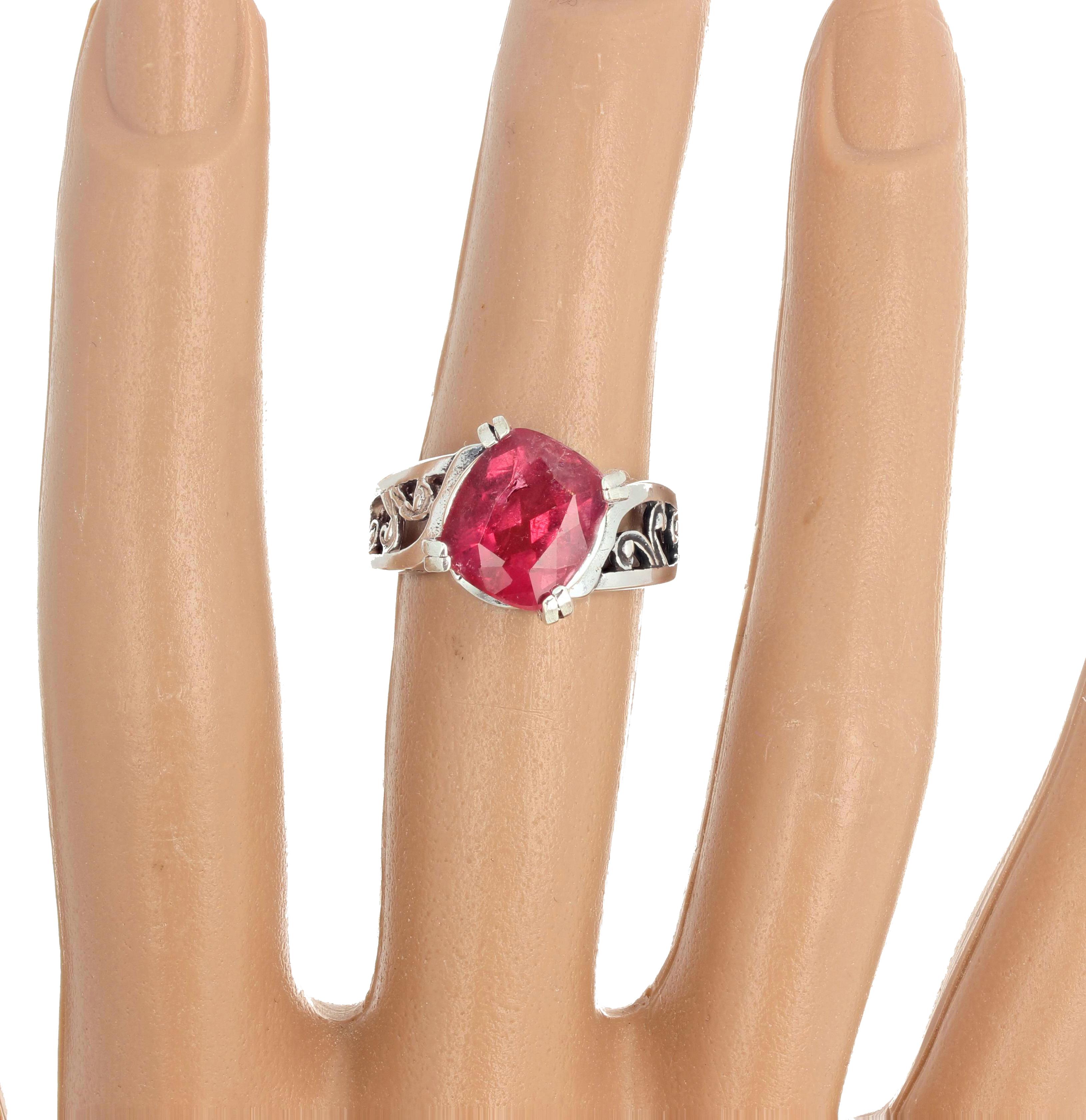 Gorgeous brilliant natural pinky red 4.7 carat Tourmaline (11 mm x 9 mm) is set sideways angled in a lovely Sterling Silver ring size 7 (sizable for free).  This is fun to wear to all occasions.  