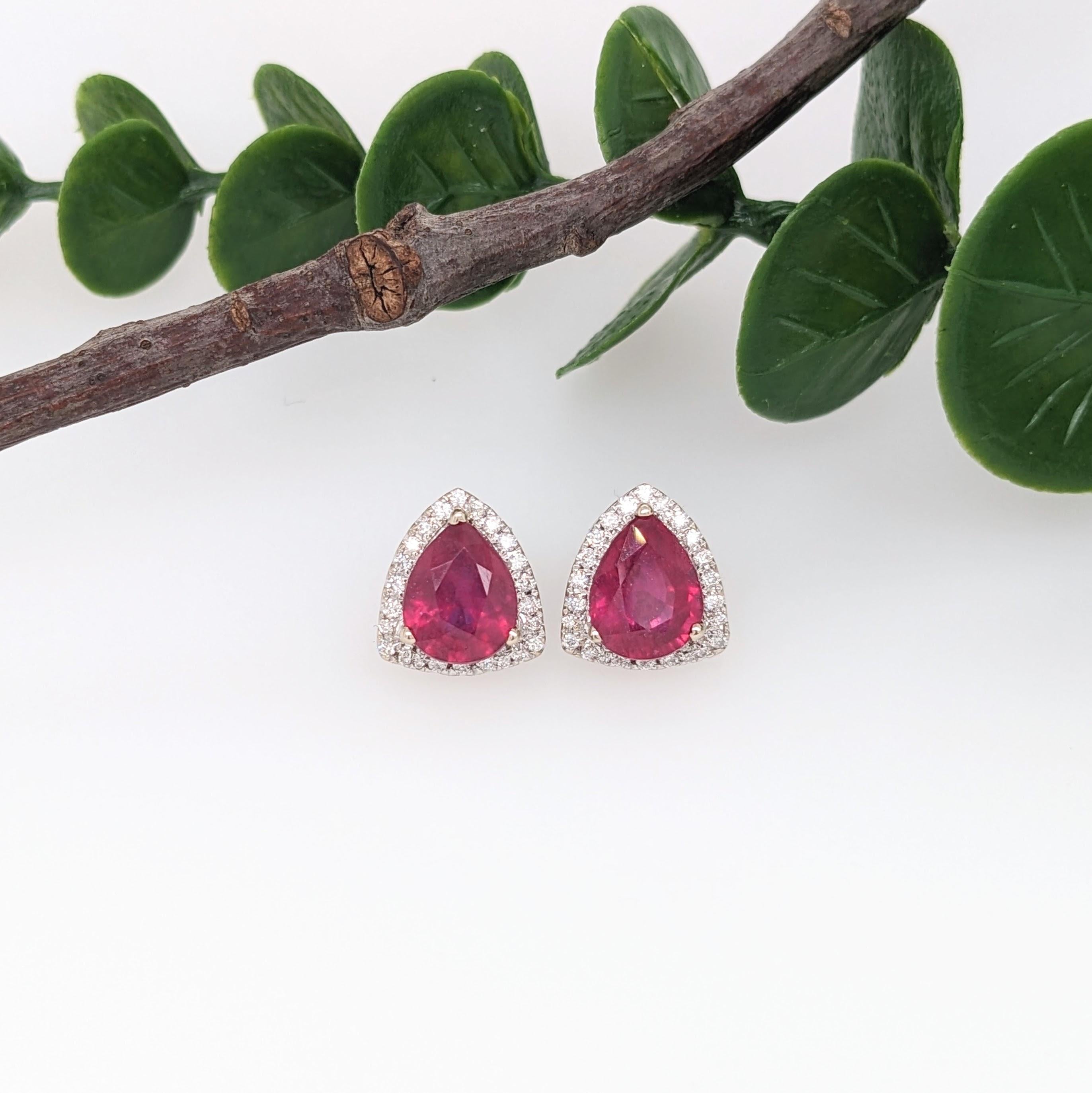 Specifications:

Item Type: Earring Studs

Center Stone Specs:
Type: Ruby
Weight: 4.7cts (2)
Shape: Trilliant
Size: 9x7mm
Treatment: Filled
Hardness: 9
Origin: Madagascar

Gold Purity: 14k/ 3.86 grams
Diamonds S/I GH: 52 diamonds totaling 0.27