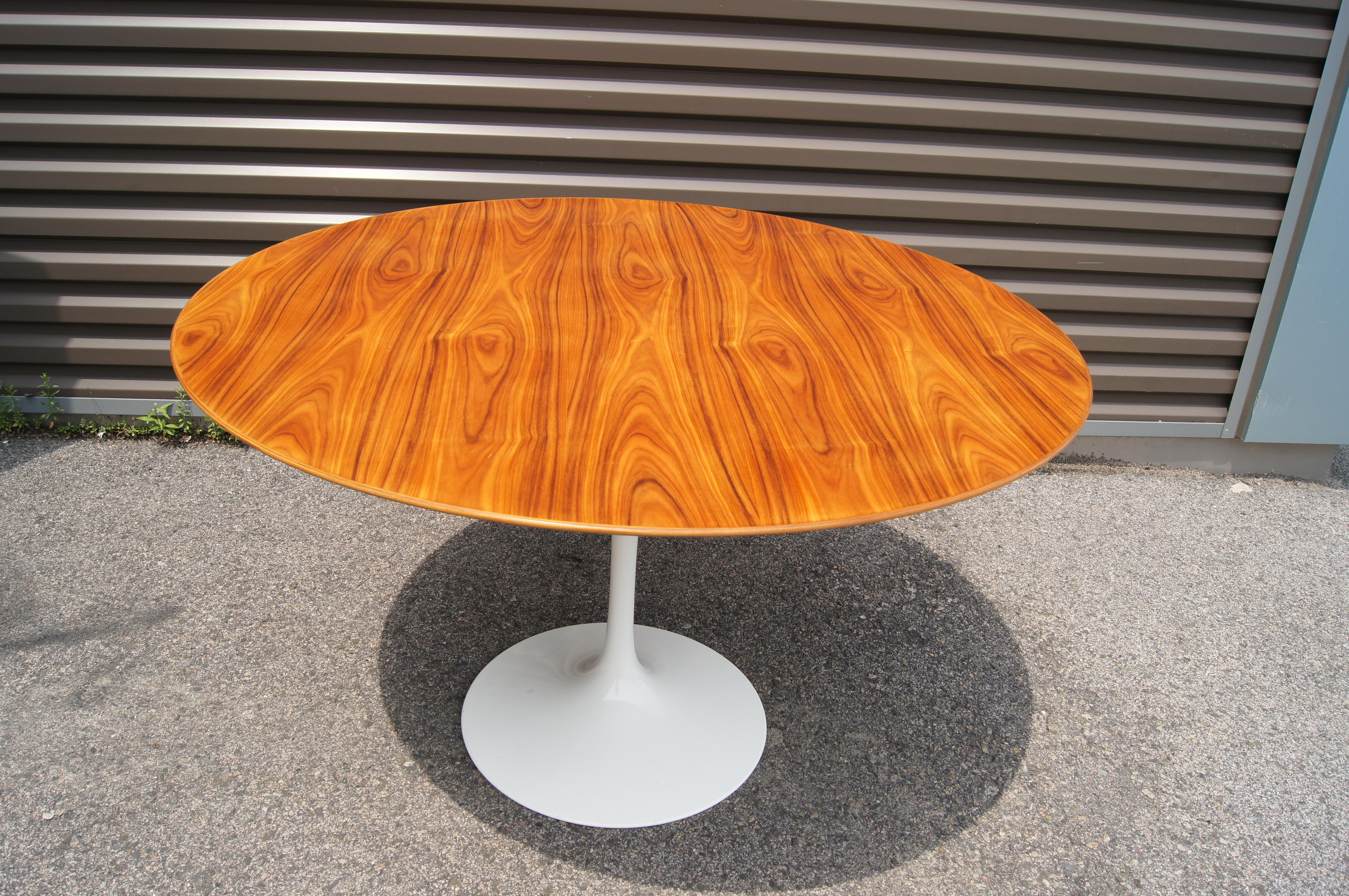 This iteration of Eero Saarinen's 1957 pedestal dining table, a modernist classic, features a round walnut top on a white cast aluminum base. The 47-inch diameter seats up to six people.

A later Knoll production from 2009, it has been newly
