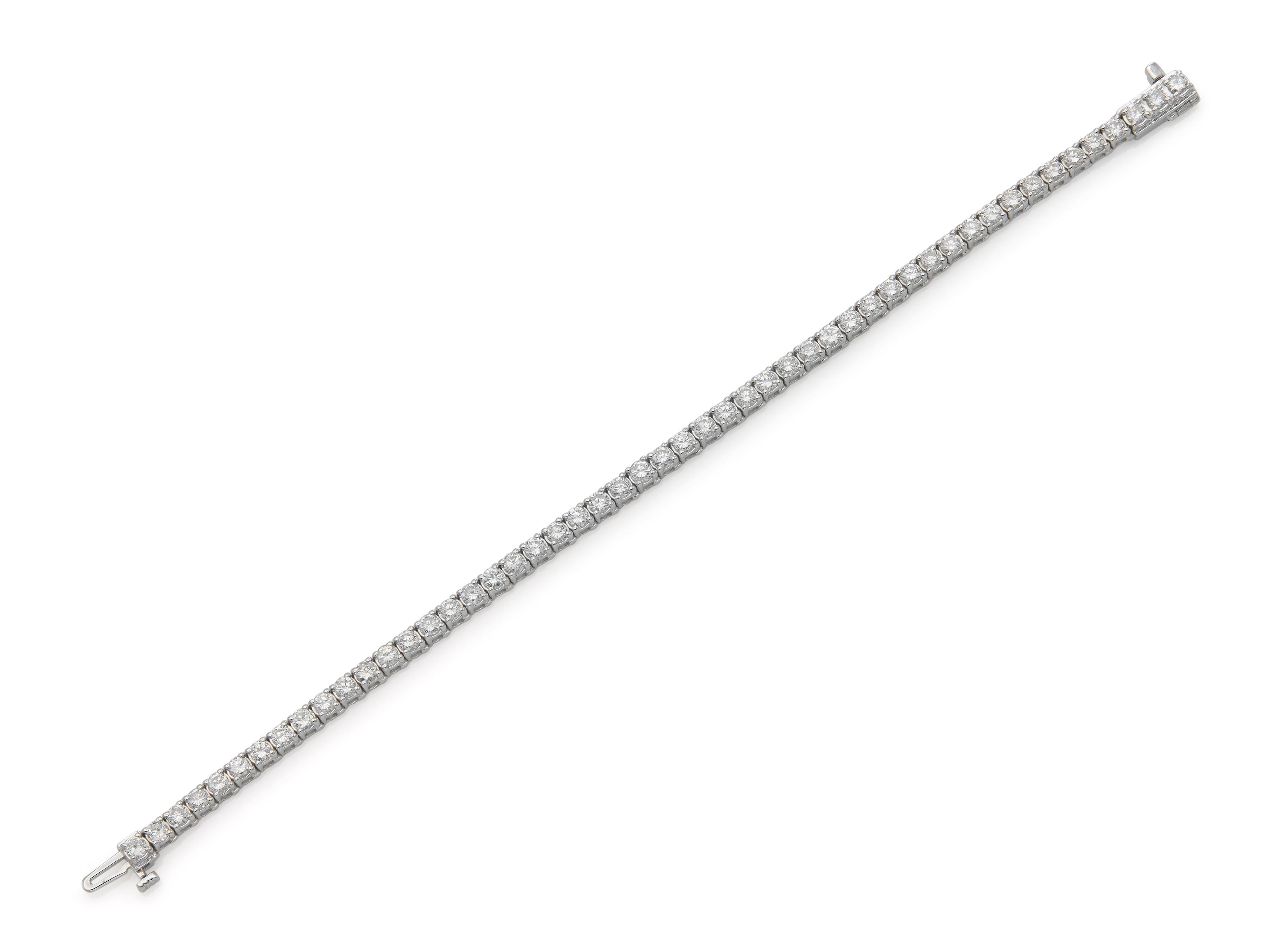 Finely crafted in 18k white gold with 51 Round Brilliant cut Diamonds weighing approximately a total of 4.70 carats, G-H color, VS clarity.
Size 6 7/8 inches