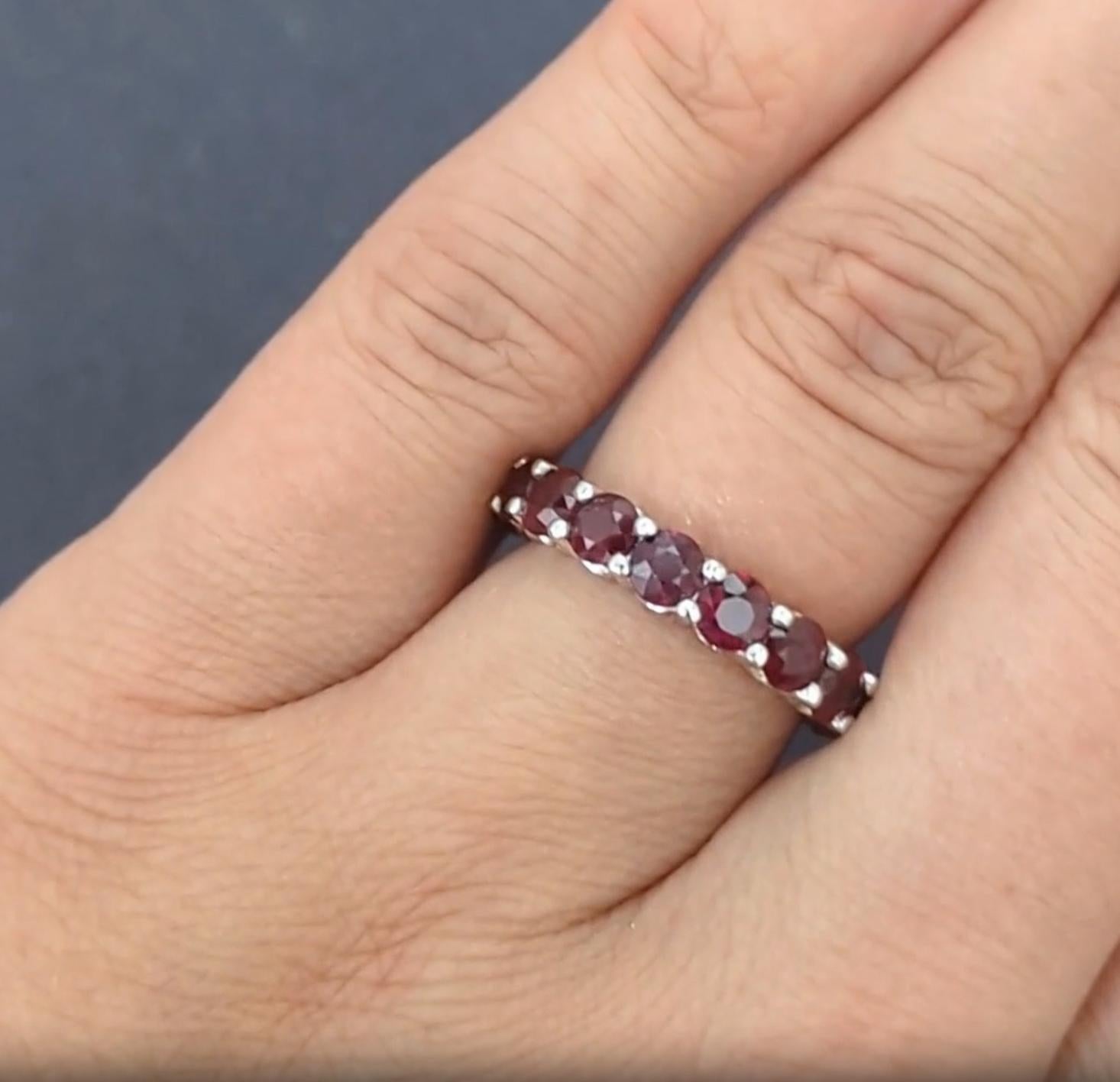 This stunning ruby eternity band showcases 4.70 carats of vibrant, natural red rubies, elegantly set in a timeless design that never goes out of style. Whether worn alone or paired as a wedding band or stacking ring, its beauty is