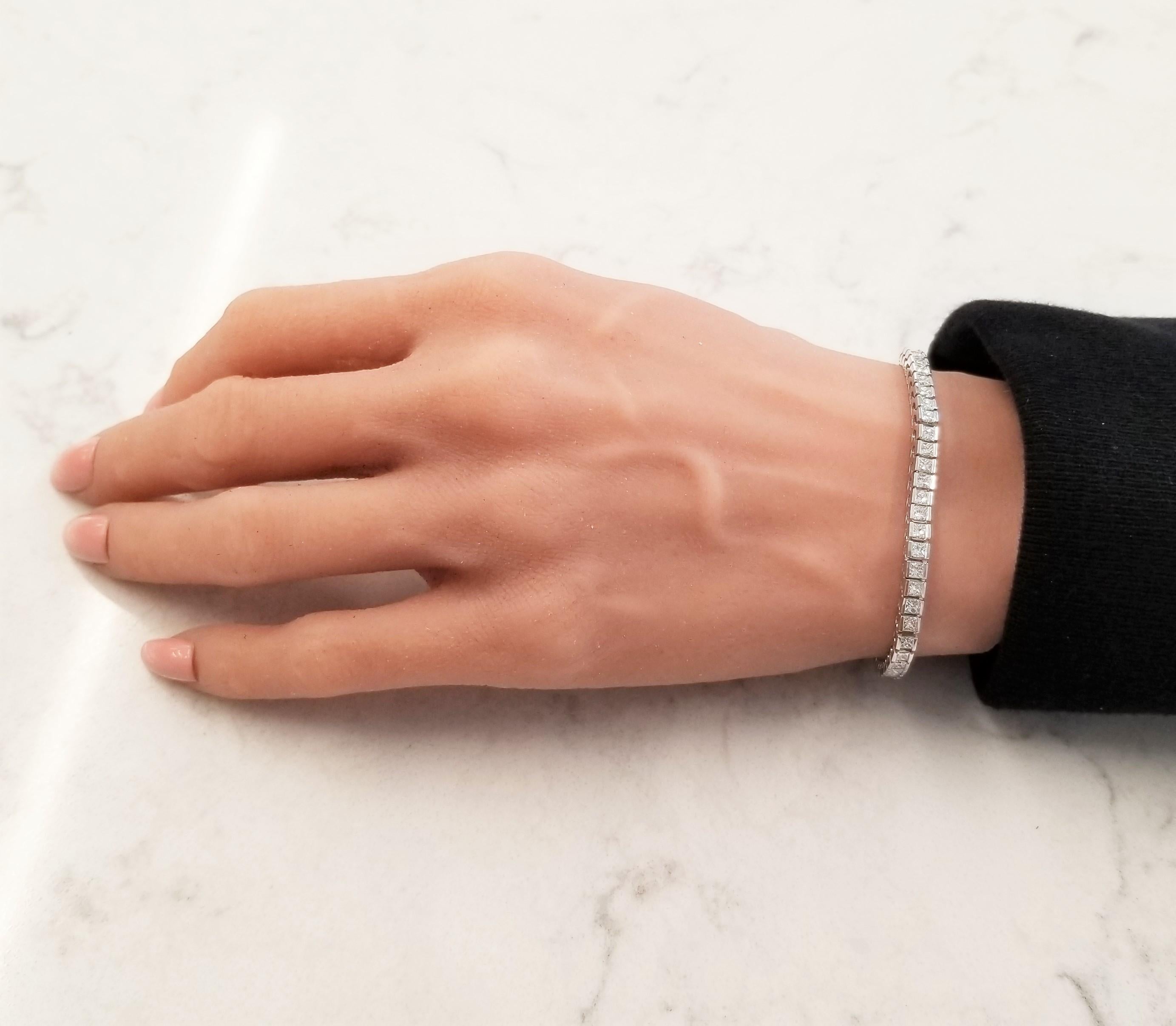 A bracelet fit for a princess! The bracelet features a remarkable 4.70 carat total of dazzling diamonds, channel set into a luxurious platinum mounting. Clean and modern, different from the typical round diamond tennis bracelet.  It's perfect to