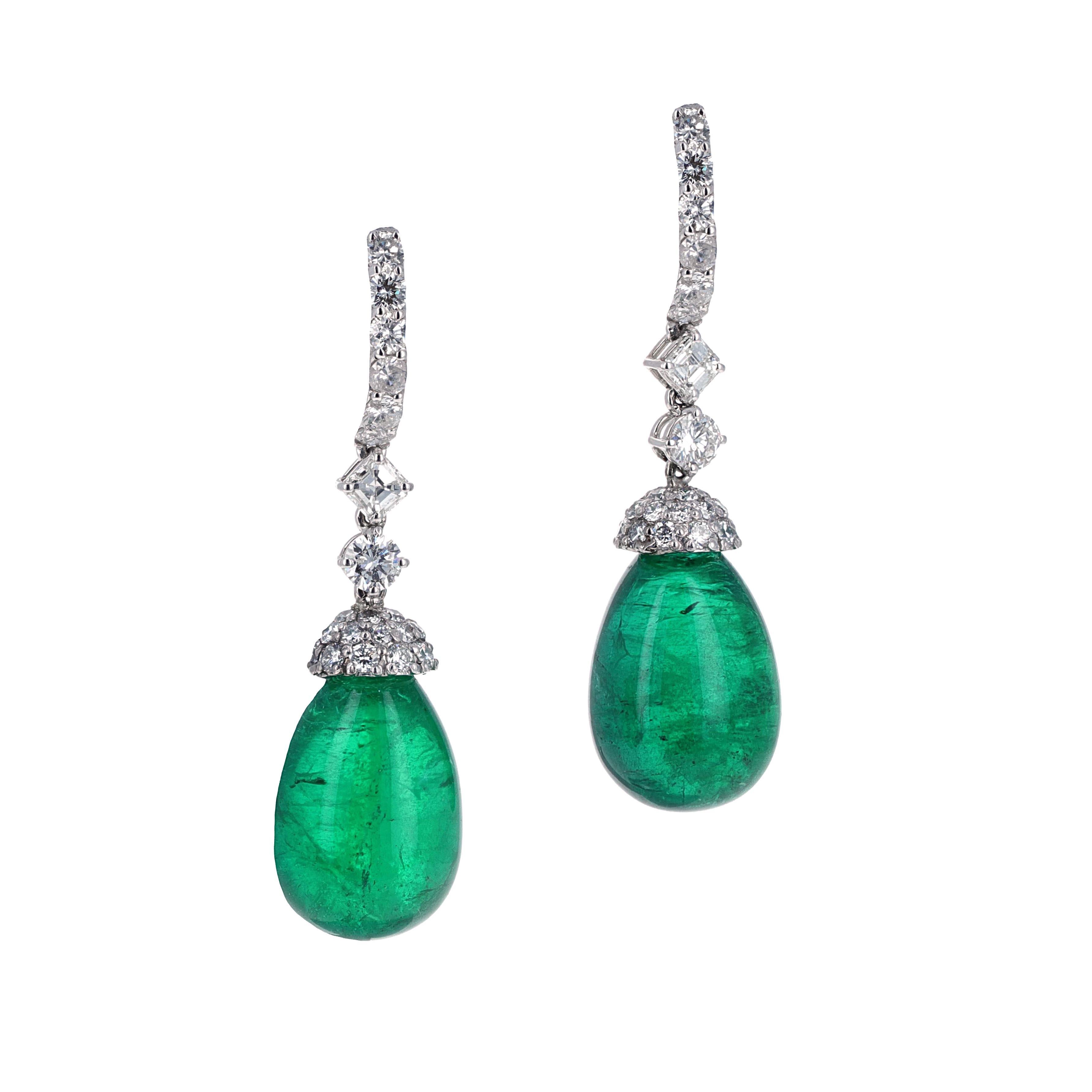 Beautiful natural green emerald cabochon drop earrings hanging from bright white diamond hoops. The emeralds match perfectly in size and weigh a total weight of 47.08 carats. When a stone is cut as a cabochon there are no facets but have very high