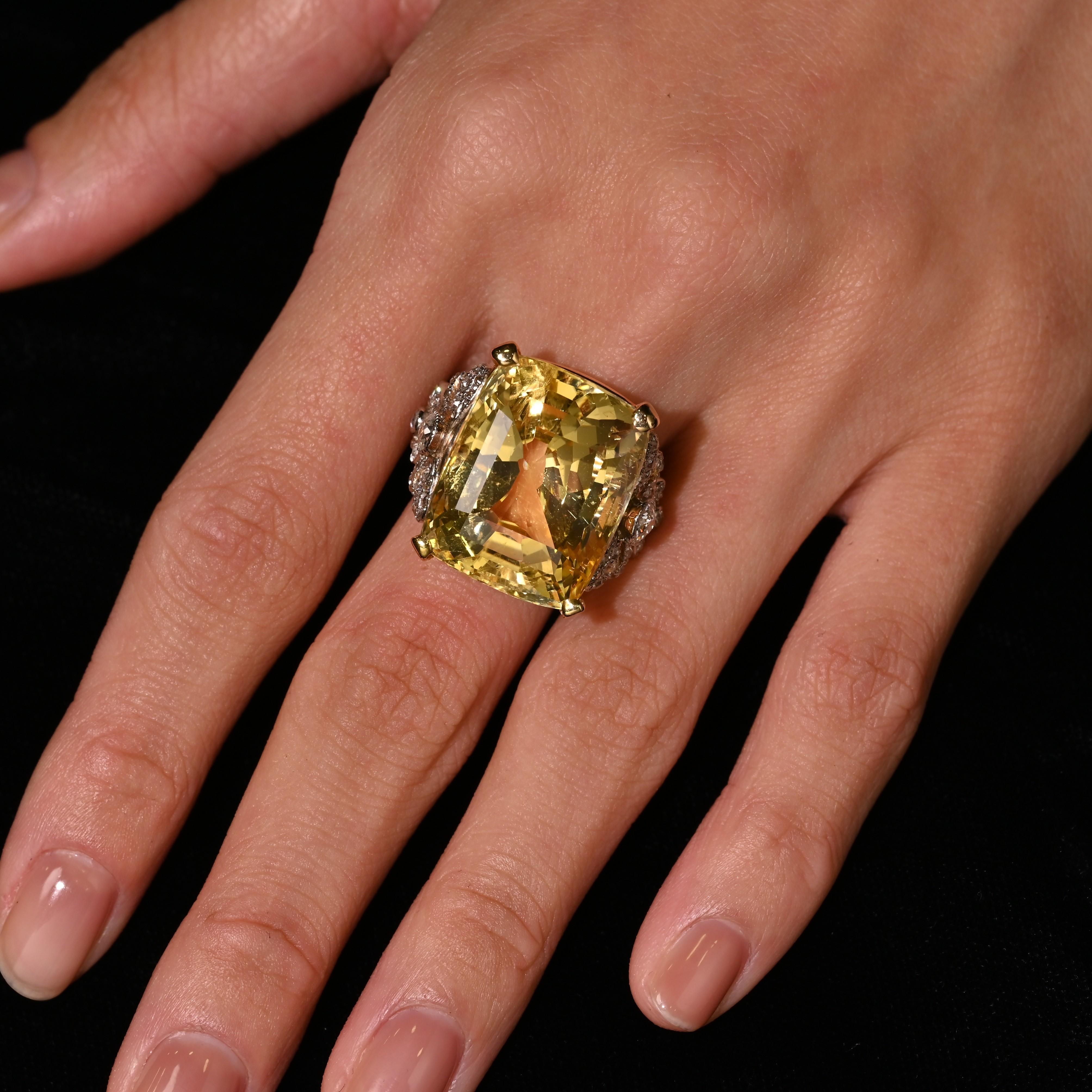 Rare GRS Certified 47.10 Carat Unheated Rectangular Cushion Cut Yellow Sapphire of Sri Lanka (Ceylon) Origin. Set in a vintage two tone platinum and 18k gold ring setting. Flanked by 50 old-cut natural diamonds. The ring setting bears a hand made
