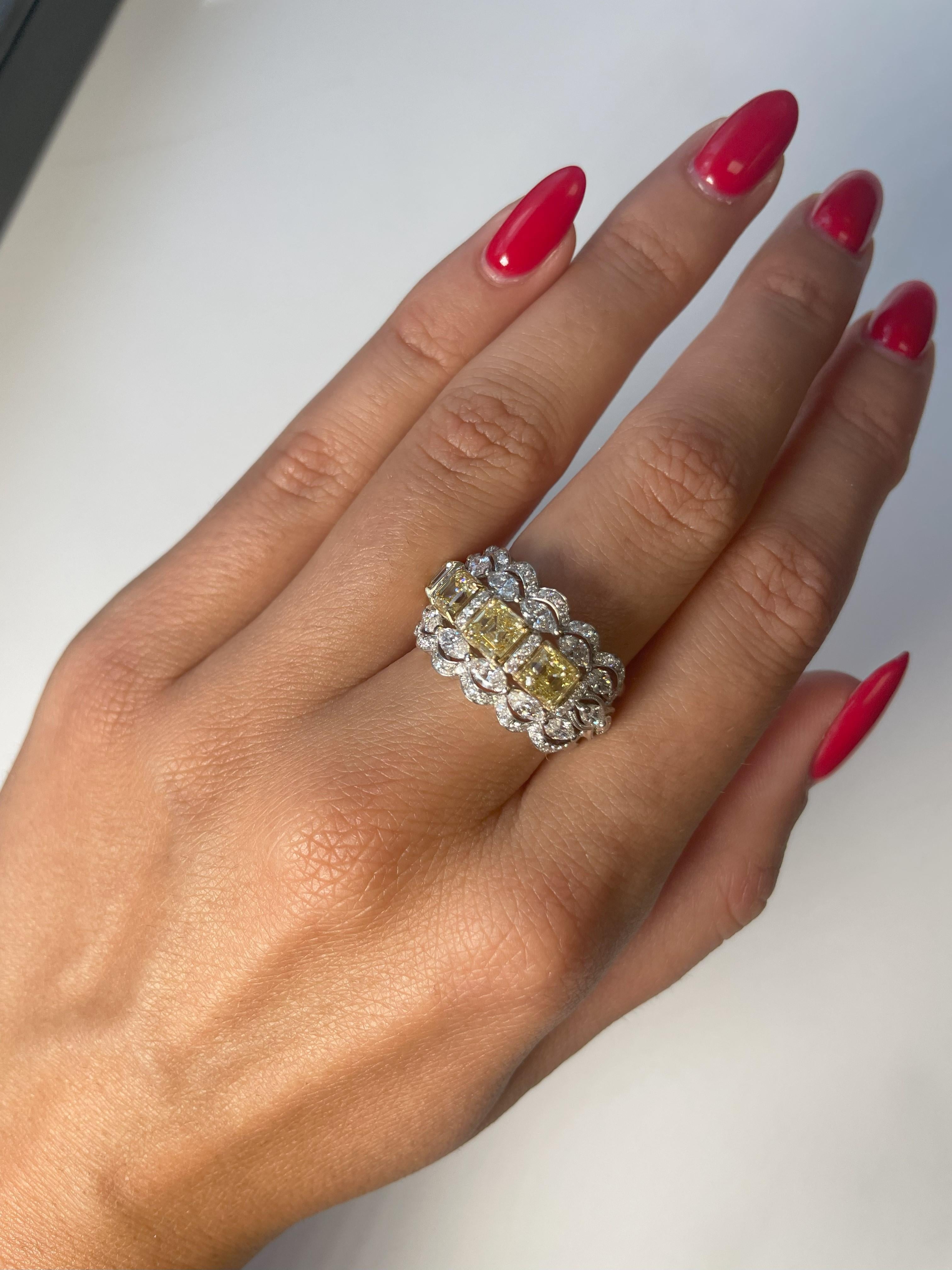 Introducing a stunning and elegant wedding band design featuring a stunning row of four perfectly matched Fancy Yellow diamonds Asscher-cut, with a combined weight of 2.67 carats. This centerpiece is elegantly encircled by two rows of marquise-cut