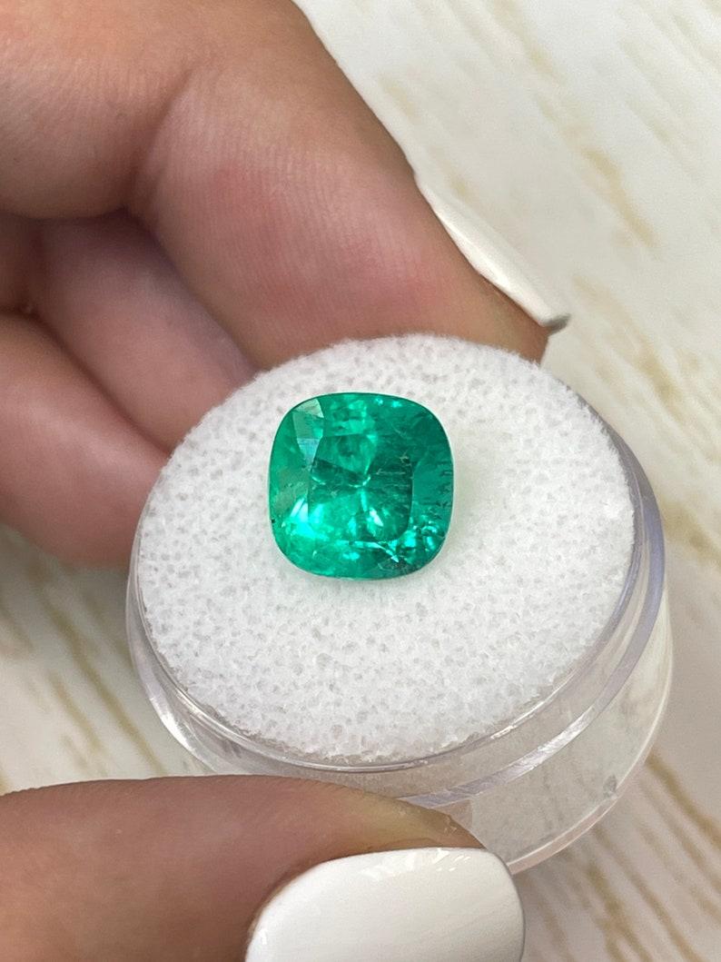 Stone: Emerald
Weight: 4.72-carats
Shape: Cushion Cut
Clarity: Transparent
Luster: Excellent to Very Good
Color: Yellowish Green
Measurements: 9.91mm x 9.99mm x 8.31mm
Geographic Origin: Colombia
Treatment: Natural, Oiling

Comments: Due to their