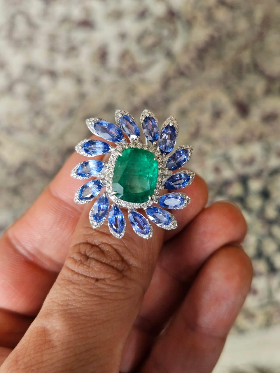 A very stunning beautiful, one of a kind, Emerald & Blue Sapphire Cocktail Ring set in 18K White Gold & natural Diamonds. The weight of the Emerald is 4.72 carats. The Emerald is completely natural, without any treatment and is of Zambian origin.