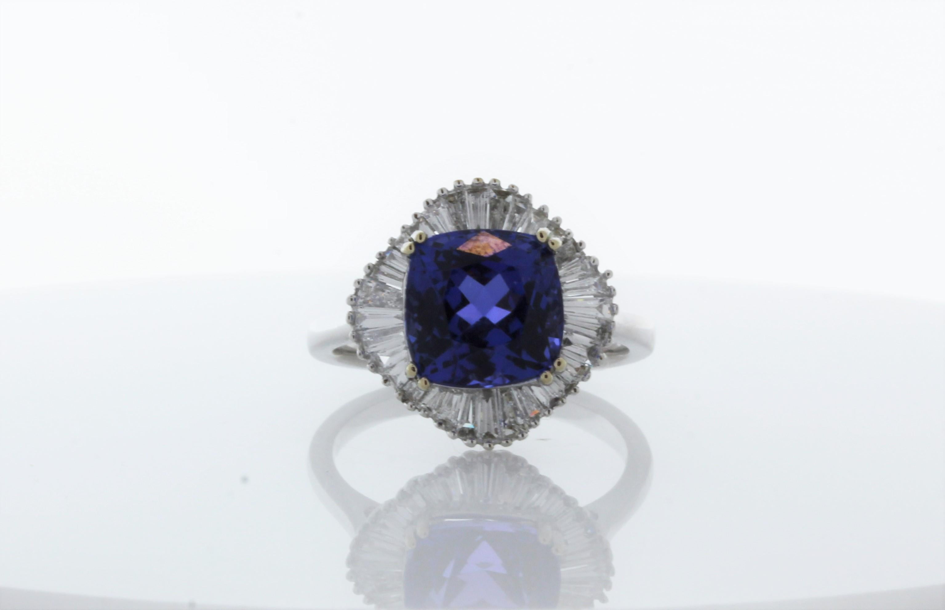 No one can resist being drawn in by the gorgeous 4.72carat oval tanzanite center. The color of this gem is vivid blue-violet, sourced from the foothills of Mt. Kilimanjaro in Tanzania. Its color is the most desired - resembling fine blue sapphire.