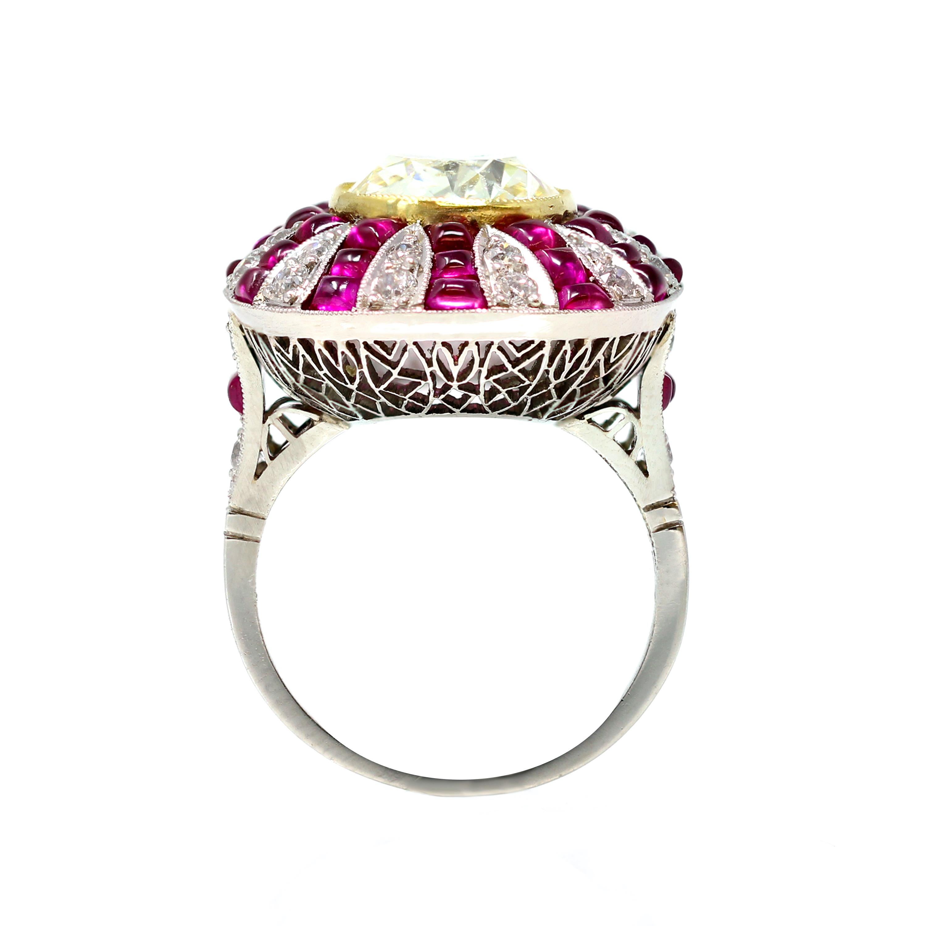 A stunning example of pure artistry for this Art Deco Style ring featuring a GIA certified Fancy yellow diamond weighing 4.73 carats skillfully adorned with cabochon rubies and old mine cut diamonds. This yellow fancy diamond and rubies cocktail