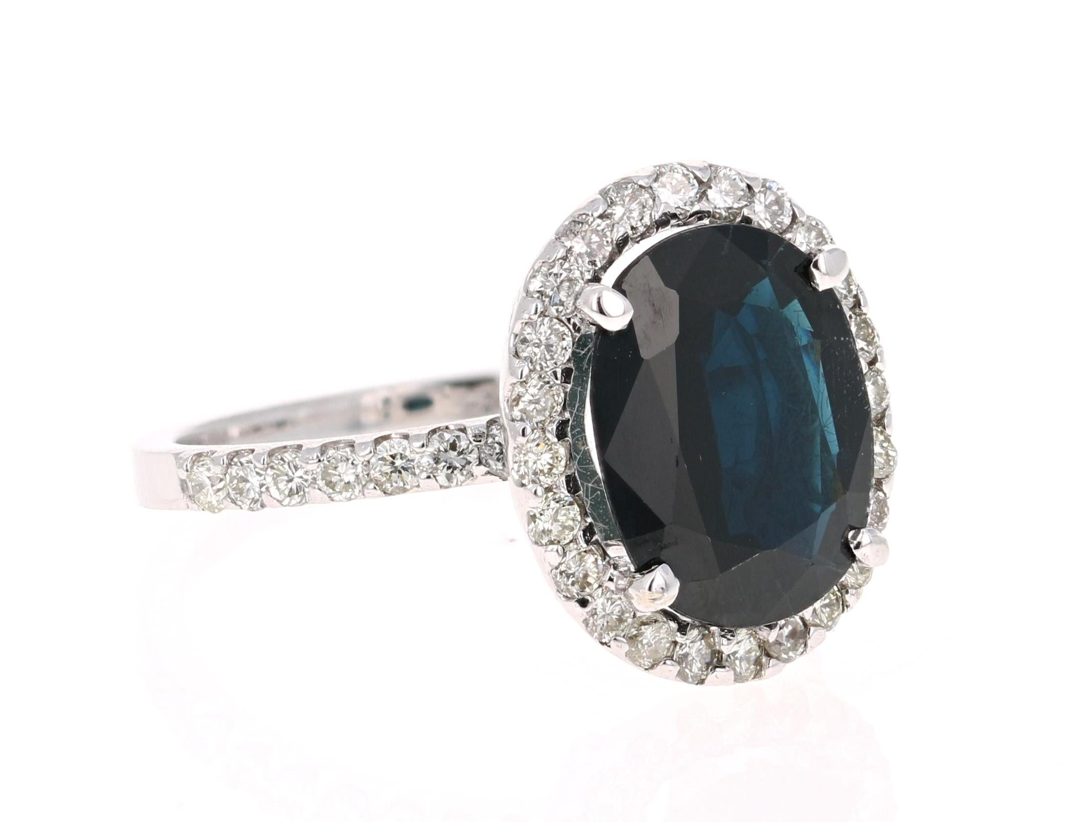 Stunning alternative to a regular diamond engagement ring! 

This dark blue sapphire ring has a Oval Cut 4.02 Carat Blue Sapphire and is surrounded by a halo of 38 Round Cut Diamonds that weigh 0.71 Carats. The total carat weight of the ring is 4.73