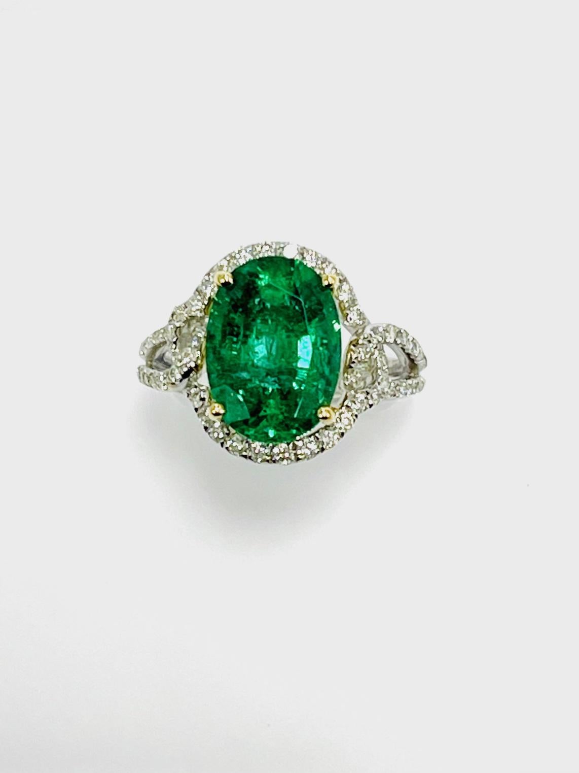 4.73 Carat oval shape Zambian emerald set in 18k white gold ring 0.54 carat Diamonds .