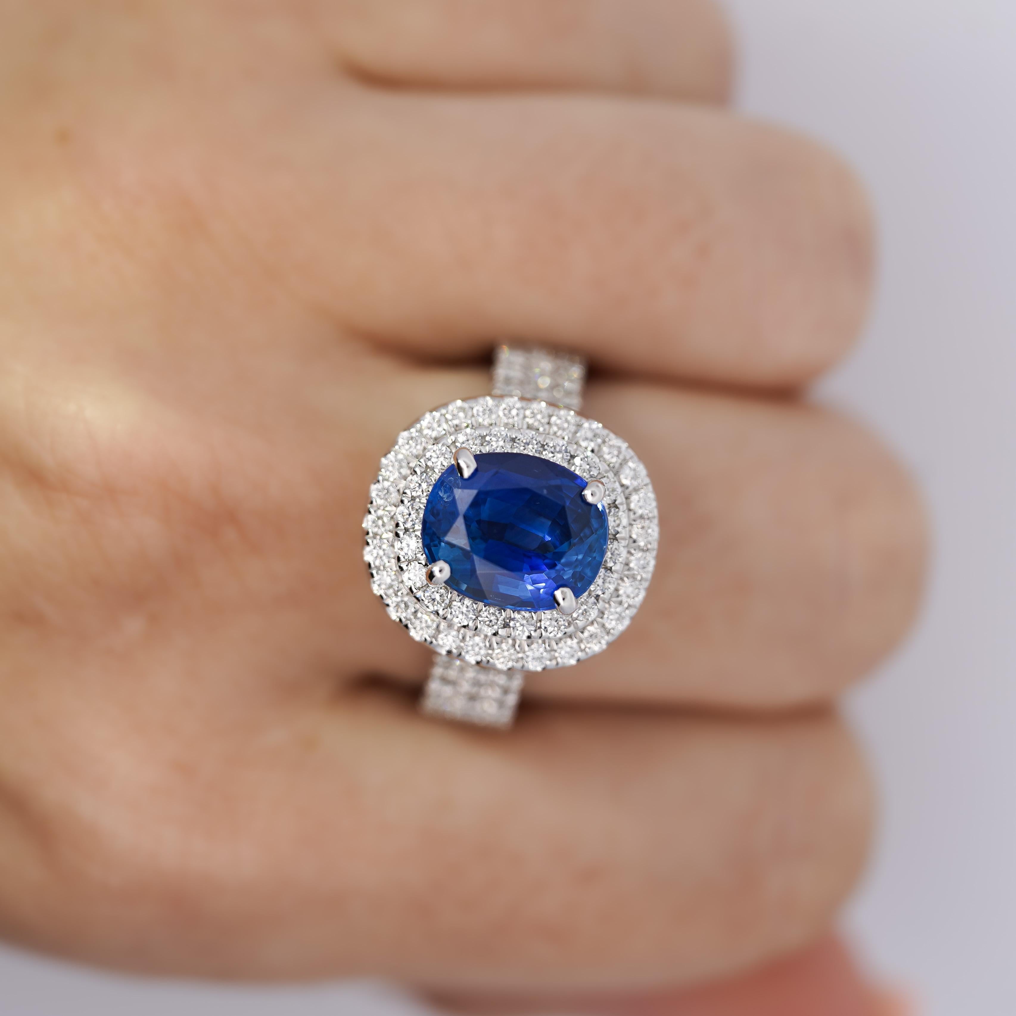 GRS Certified 4.73 Carat Blue Sapphire of Ceylon Origin with Pave Set Double Round Cut Diamond Halo.

Set in 14K white gold, this ring weighs 11.64 grams and is currently a size 9, ensuring both comfort and style. The sapphire is GRS certified