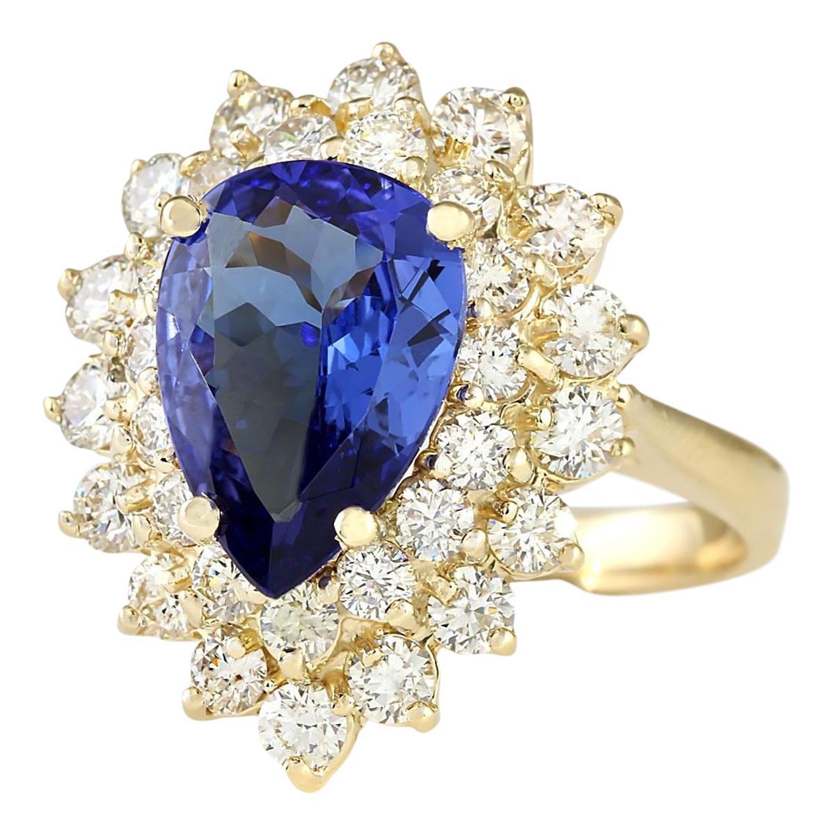 Introducing our stunning 4.73 Carat Natural Tanzanite 14 Karat Yellow Gold Diamond Ring. Crafted from luxurious 14K yellow gold, this ring is stamped for authenticity and has a total weight of 7.2 grams. At its center is a captivating 3.08 carat