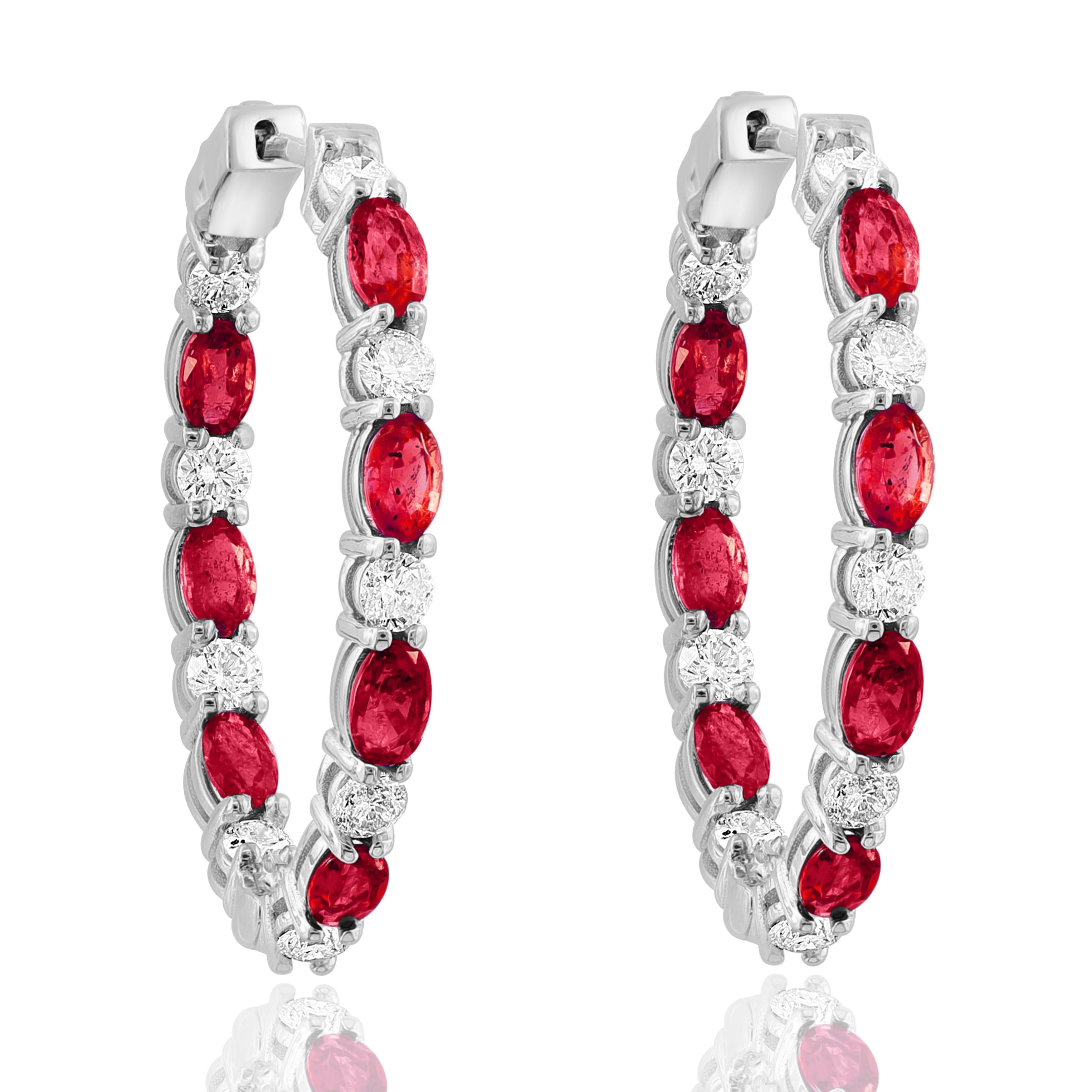 A stylish and versatile style hoop earring showcasing oval cut 14 Red Rubies weighing 4.73 carats total, channel set in a diamond-encrusted 14-karat White gold mounting. 18 Diamonds weigh 1.79 carats in total.

All diamonds are GH color SI1