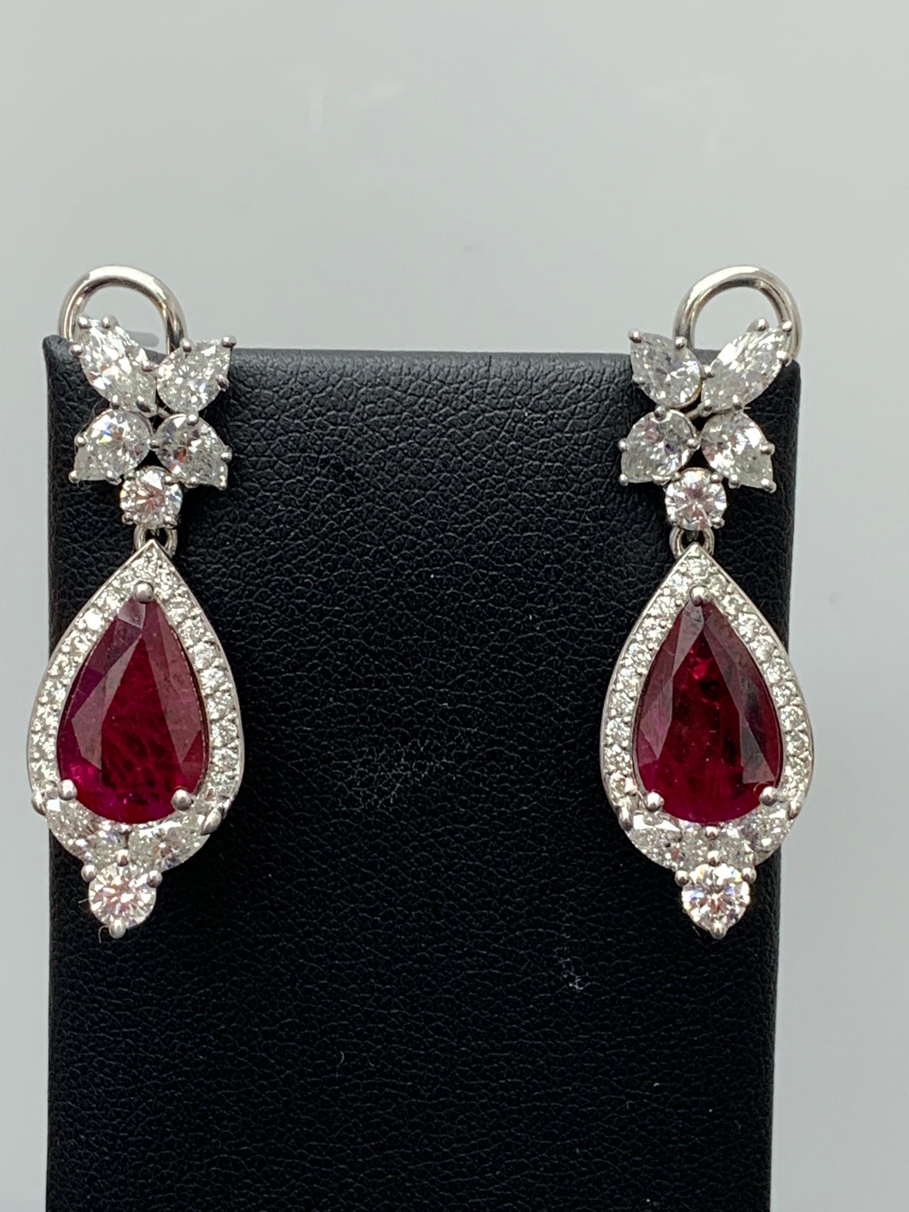 A beautiful and chic pair of drop earrings showcasing a cluster of brilliant mixed-cut diamonds, and 2 brilliant Pear shape Rubies set in an intricate and stylish design.  10 Mixed cut Diamonds weigh 1.91 carats in total. 2 rubies weigh 4.73 carats