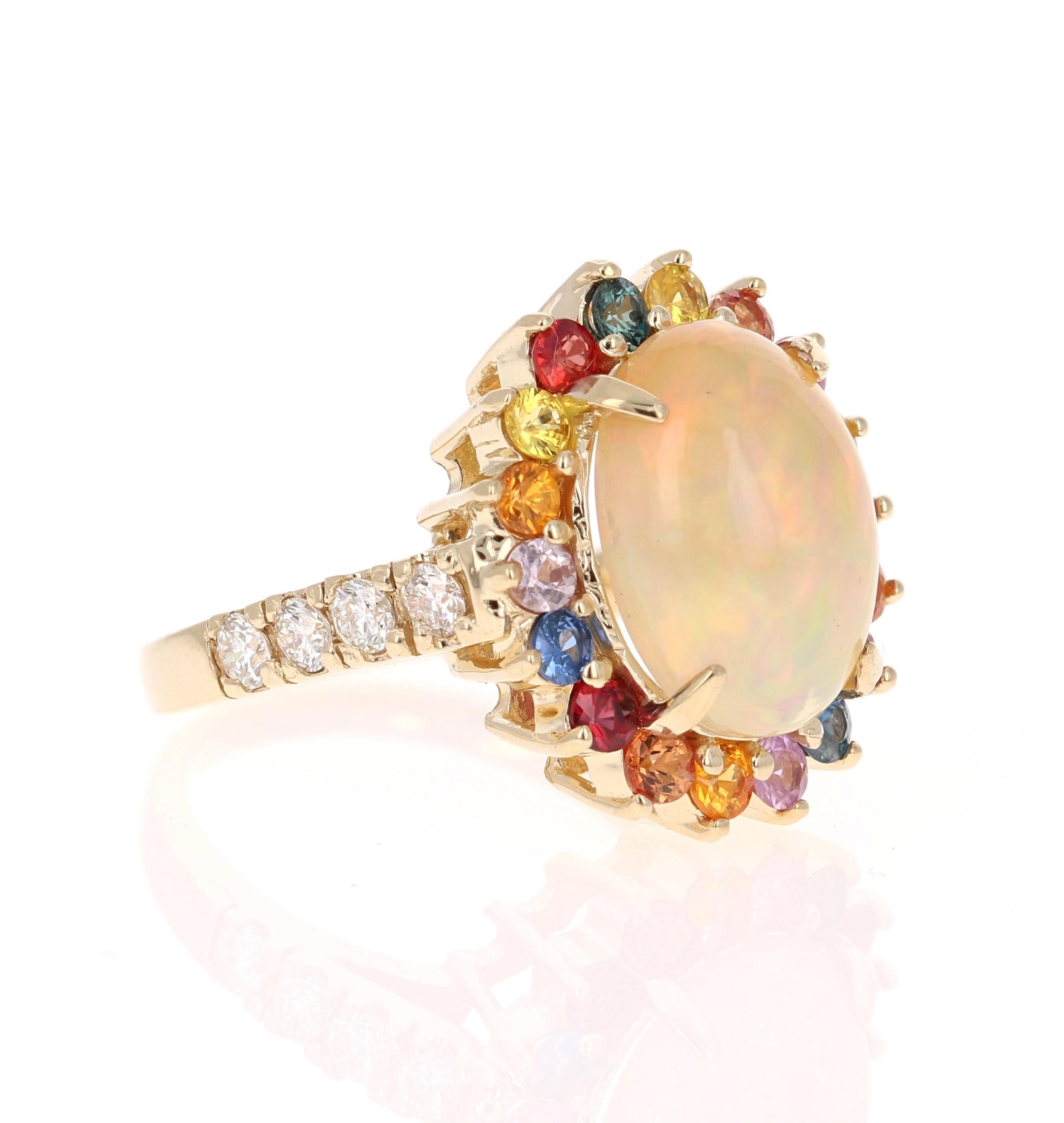Opal Multi Color Sapphire and Diamond Ring in 14K Yellow Gold

The beautiful Oval Cut, Ethiopian Opal with its striking flashes of color weighs 3.12 carats. It is surrounded by 18 Multi-Colored Sapphires that weigh 1.14 Carats and 8  Round Cut