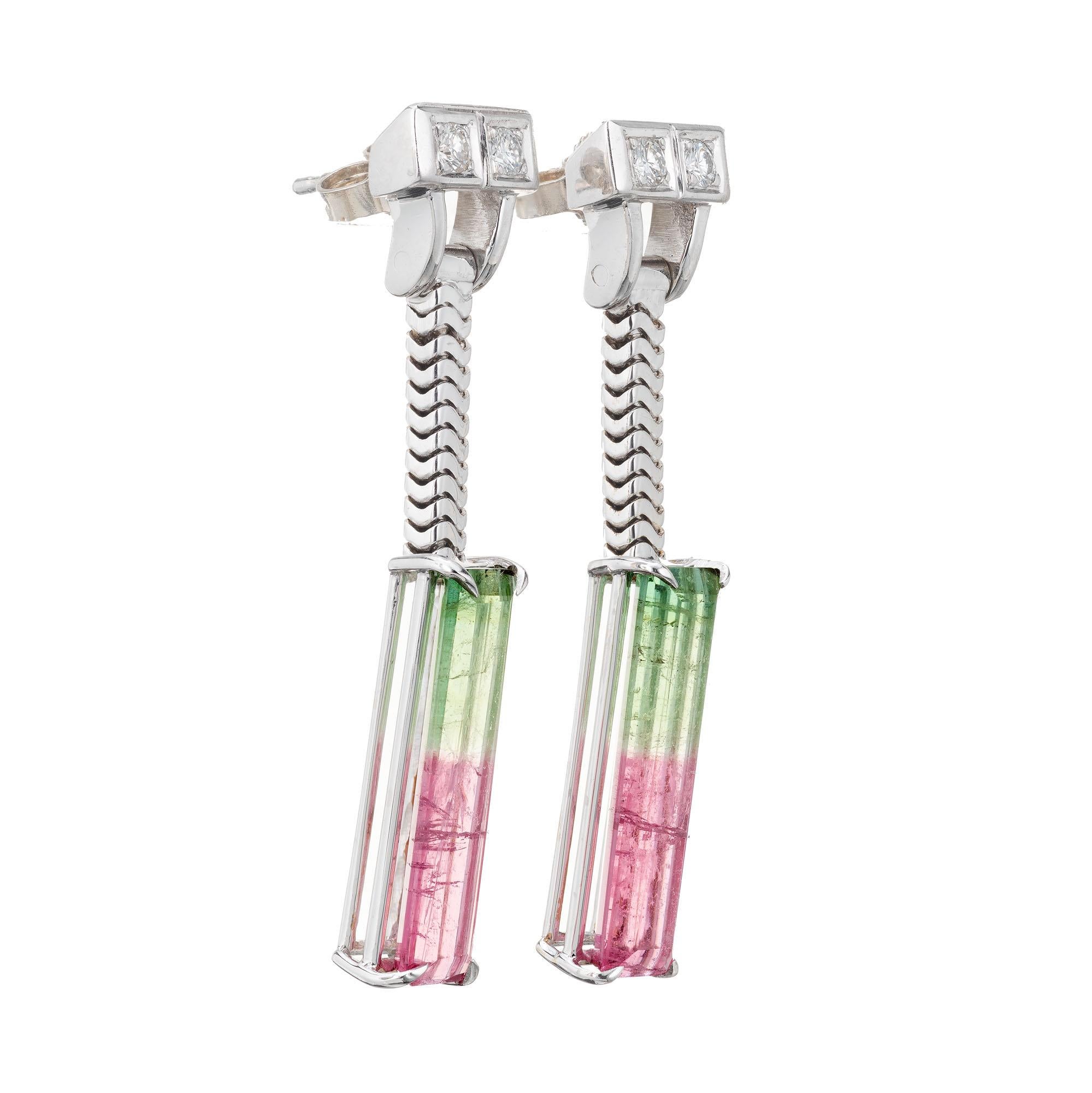 Art Deco dangle tourmaline earrings with diamond accent tops. 14k White gold snake chain dangle and a matched pair of distinct bi-color pink and green Tourmaline bottoms. Circa 1940-1950.

2 natural pink and green Tourmaline, approx. total weight
