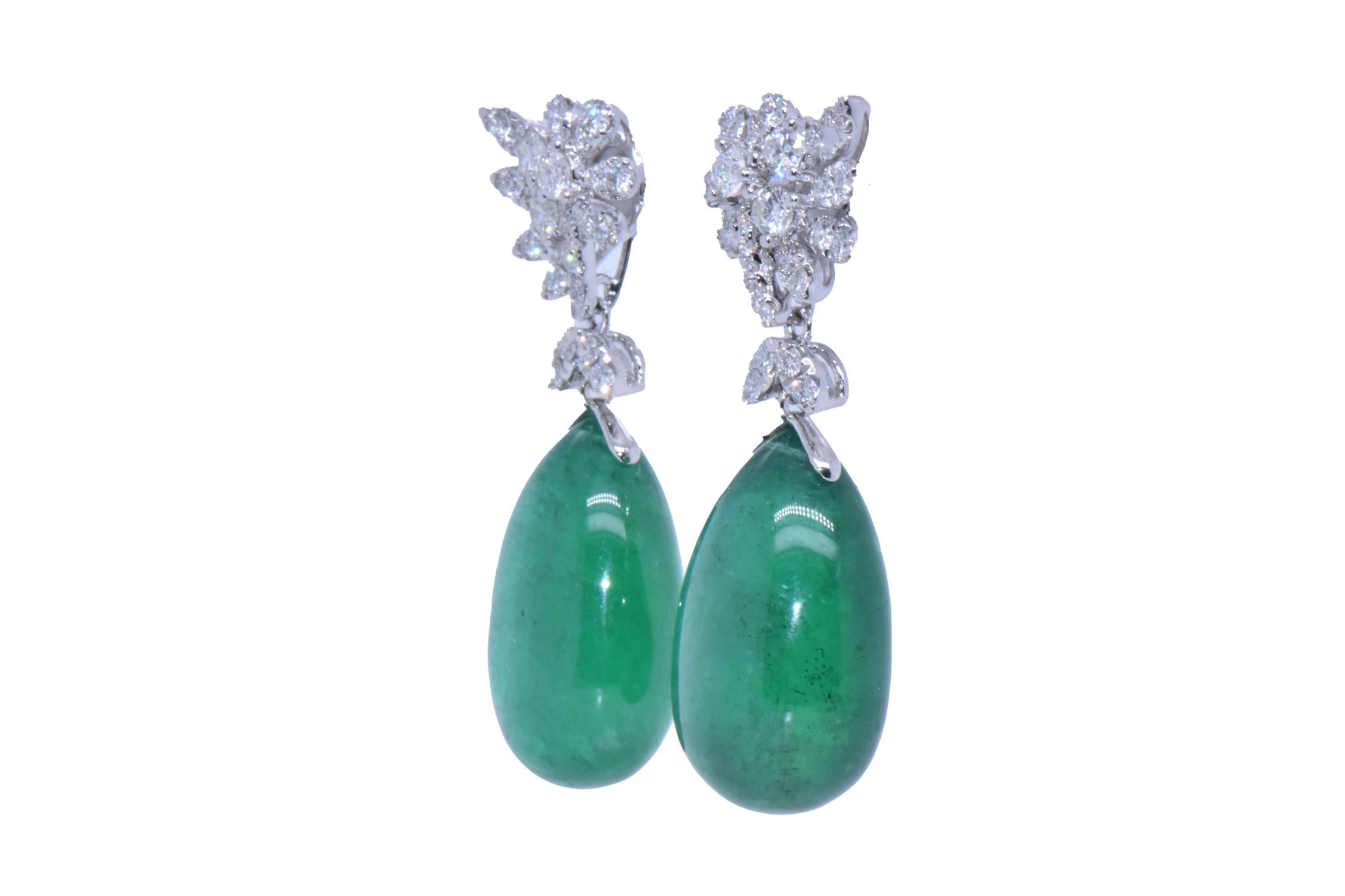 47.41 Carat Emerald Drop Earrings with Diamond Flower Design in 18k White Gold
Stunning Natural Emerald Drop Earrings Comprising of Two Pear Cabochon-Cut Natural Emeralds weighing 47.41 Carats. Excellent deep green color. The earrings are also