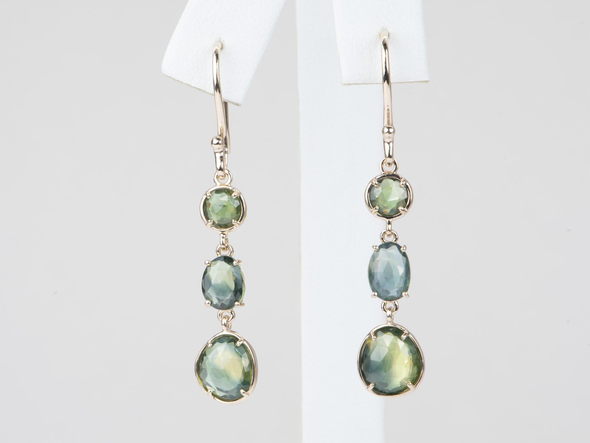 ♥ Solid 9k gold earrings set with beautiful freeform-shaped Madagascar sapphires
♥ Gorgeous blue green color!
♥ The item measures 43mm in length including the ear wire, 8.3mm in width, and stands 2.4mm tall

♥ Gemstone: Sapphire, 4.74ct total
♥ All