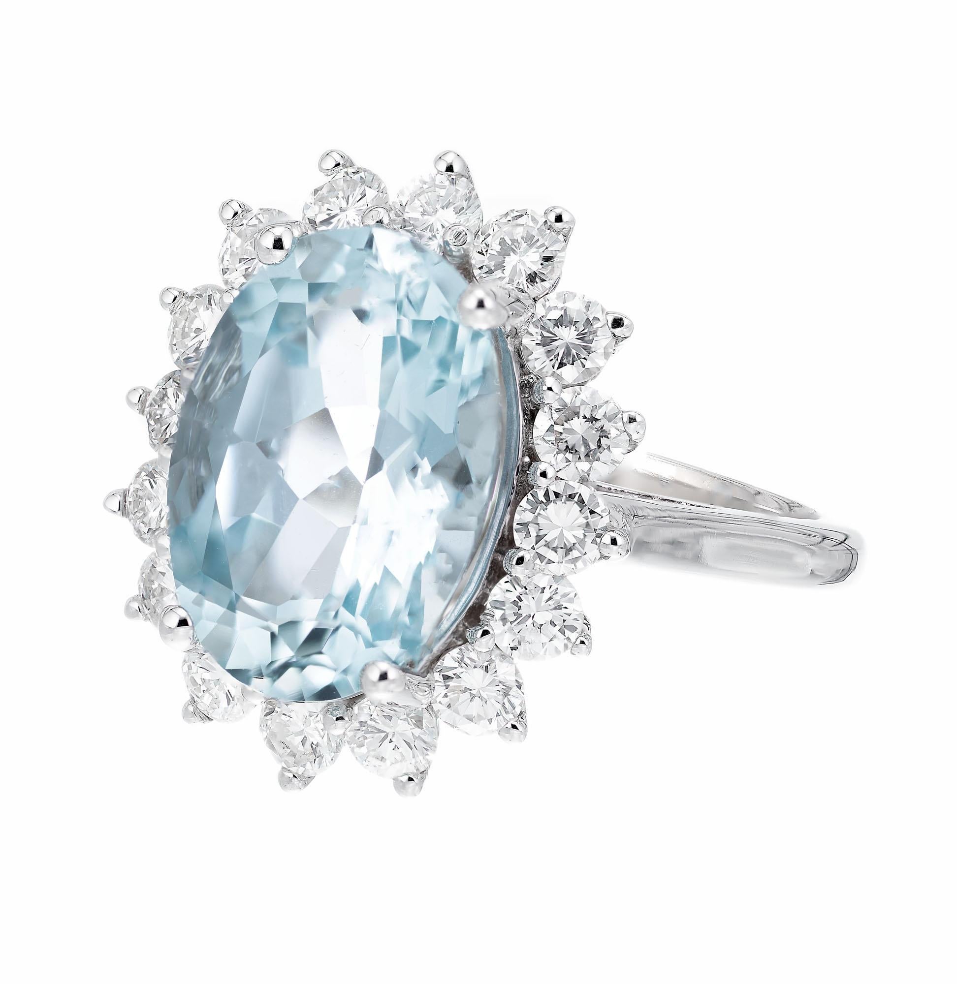 Oval aqua center stone with a halo of 16 round diamonds in a 14k white gold setting. 

1 oval faceted Aquamarine, approx total weight: 4.75cts
16 round brilliant cut diamonds, approx total weight 1.10cts  G-H, VS
Size: 6.5 and sizable
6.4