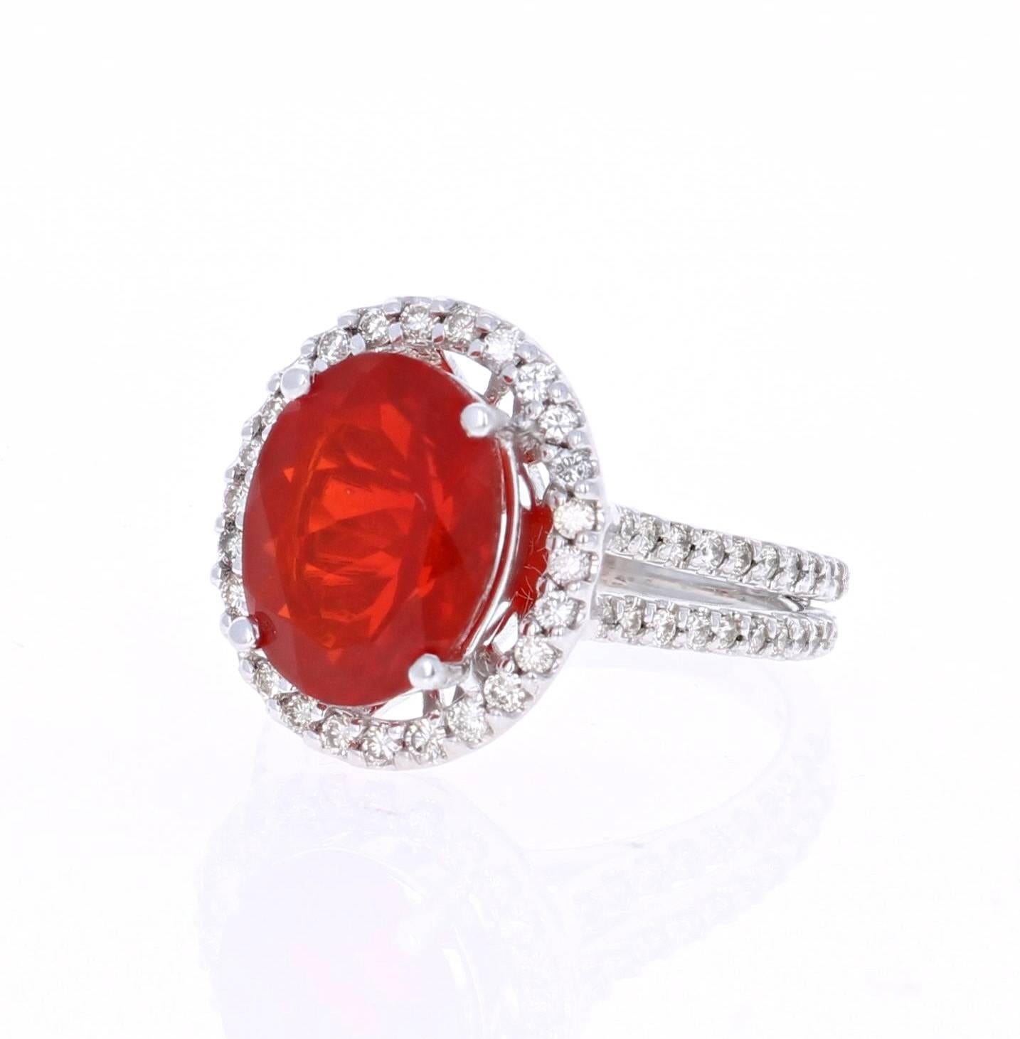 Beautiful Fire Opal and Diamond Ring that can easily substitute for a unique Engagement Ring. This ring has an Oval Cut 3.82 carat Fire Opal in the center of the ring and is surrounded by a halo of 66 Round Cut Diamonds that weigh a total of 0.93