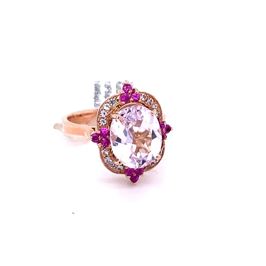 Candy Crush on your Finger!! 

This beautiful ring has a Oval Cut Kunzite that weighs 4.27 carats that is set in the center of the ring and is surrounded by 16 Round Cut White Sapphires that weigh 0.20 Carats. It also has 12 Pink Sapphires that