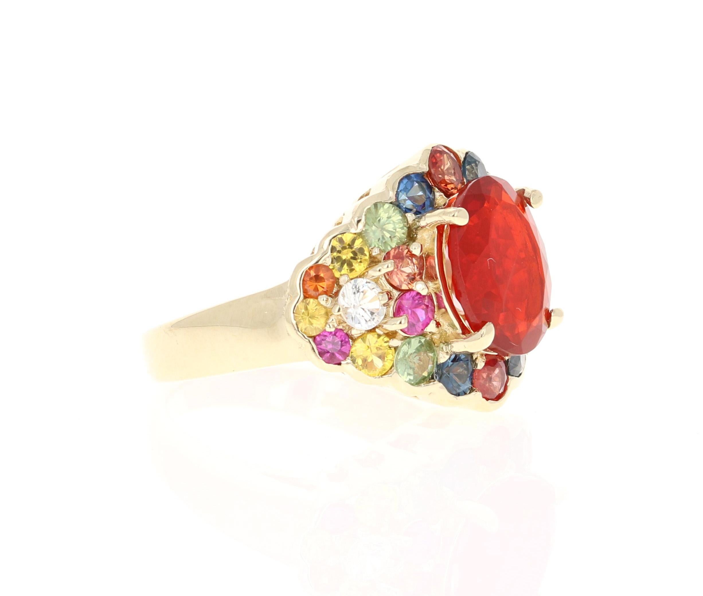 This ring has a 2.00 Carat Oval Cut Fire Opal as its center stone and is elegantly surrounded by 26 Round Cut Multi-Colored Sapphires that weigh 2.75 Carats. The measurements of the Fire Opal are 11 mm x 9 mm. 
The total carat weight of this ring is