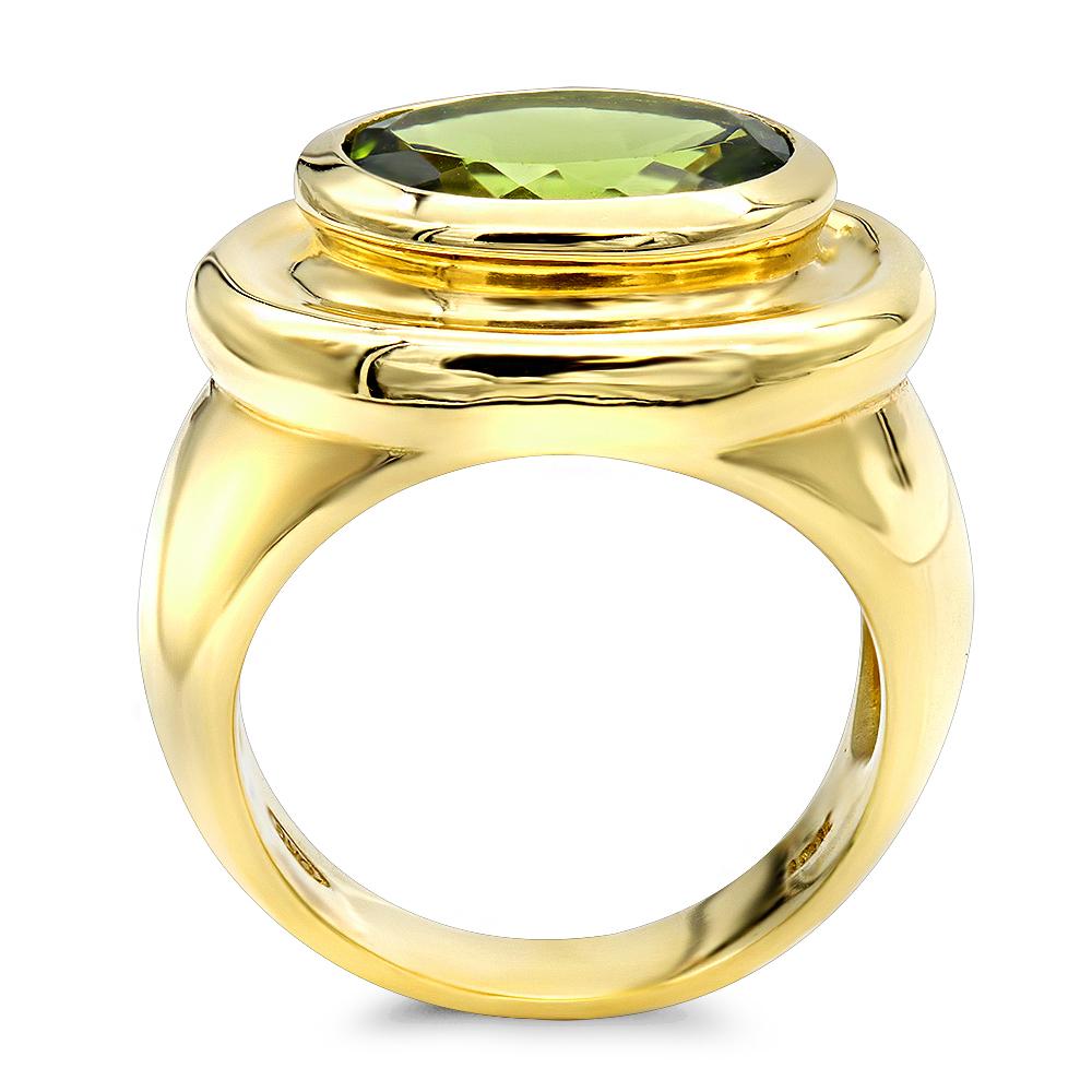 Ladies beautiful Hand made Peridot Cocktail ring.
Mounted in a heavy high polished chunky 18k yellow gold.
Oval Brilliant faceted center Peridot stone weighs 4.75 carats
Custom orders available in Blue Topaz or Citrine!
Sizing available on the