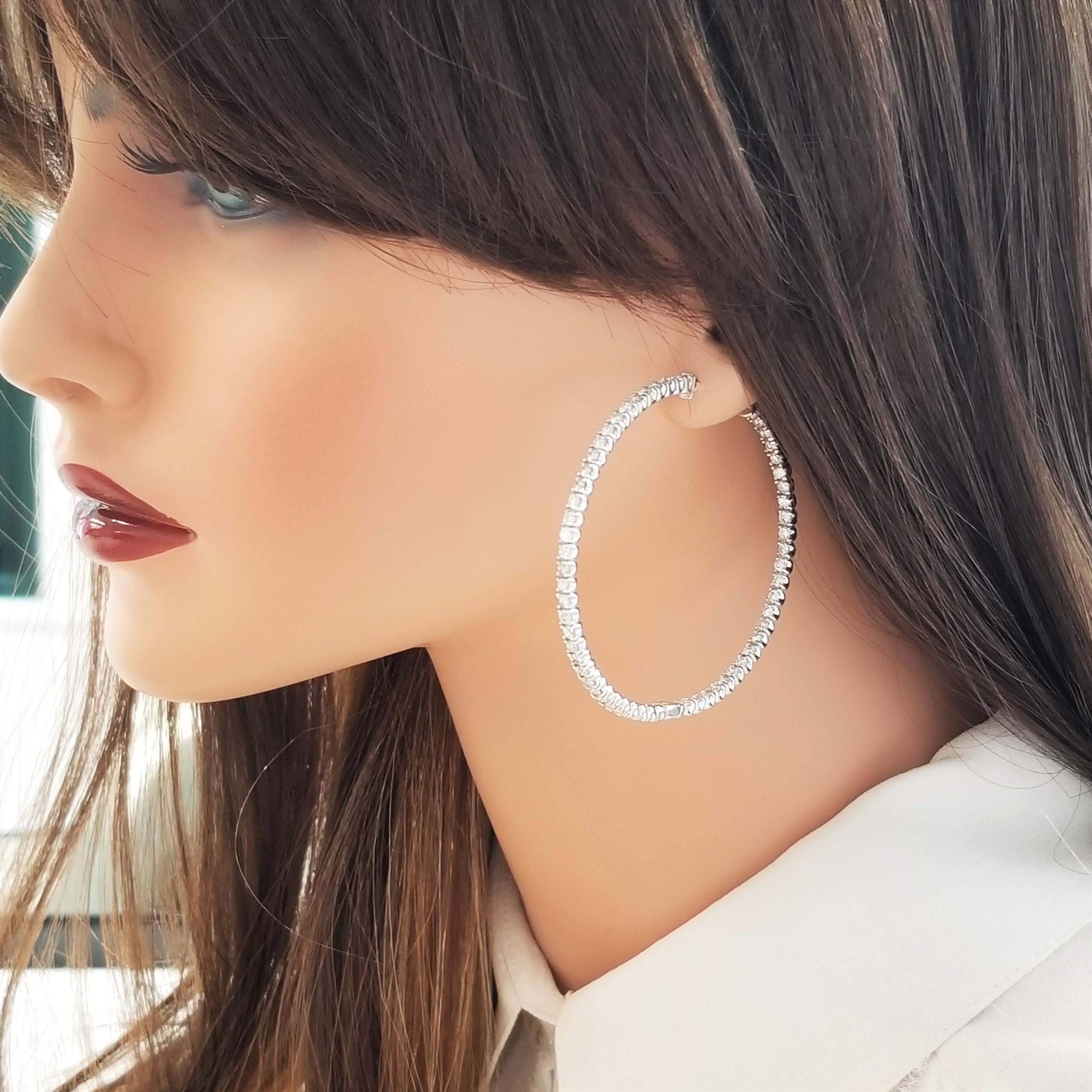 This is a lovely pair of inside & outside hoops, set with 114 stunning diamonds. 4.75 carats face forward, the only direction that matters! Precision set in 14 k white gold earrings, these diamond hoops take it to the next level.
