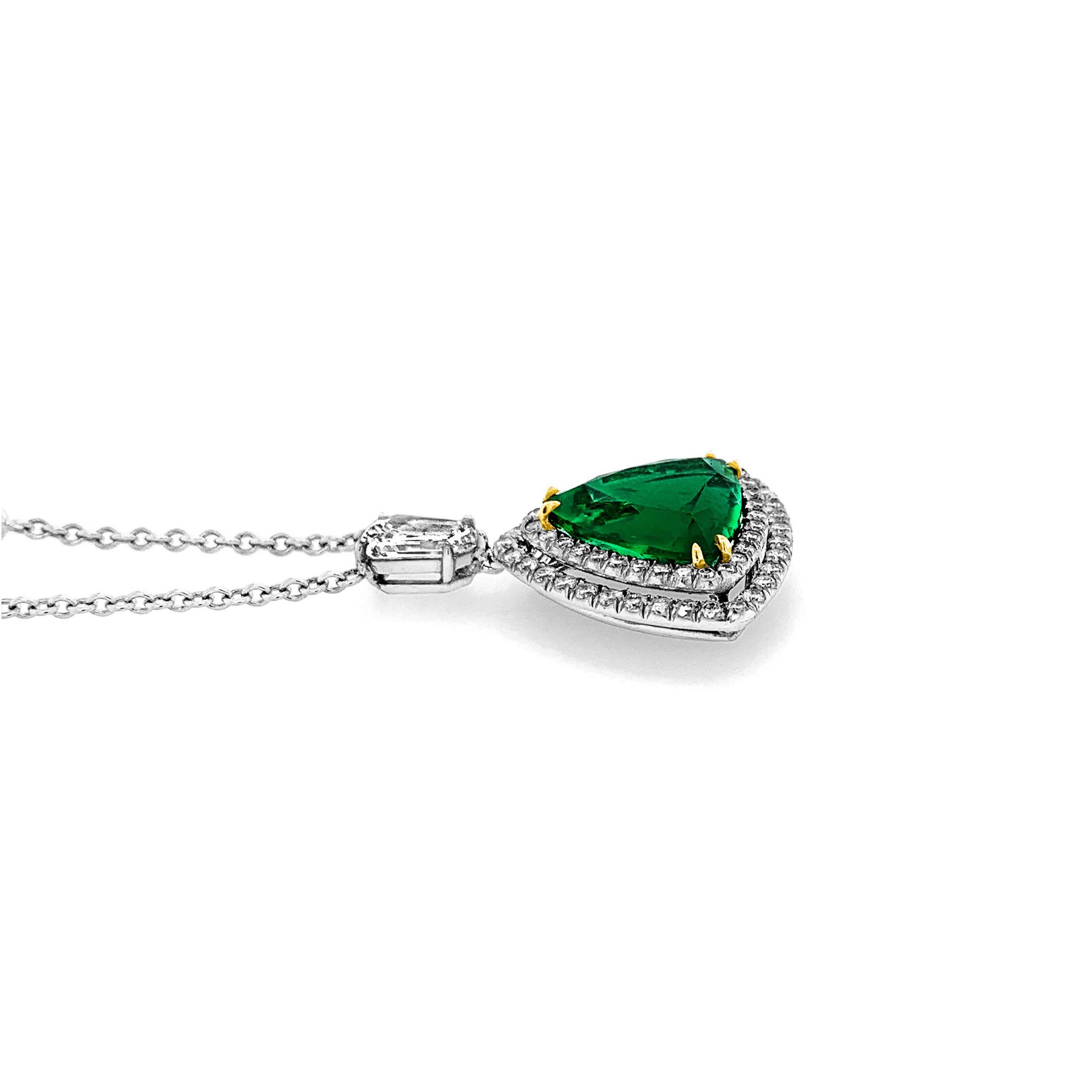 4.75 Carat Trillion Cut Emerald in 18K Yellow Gold Mounting with Round Brilliant Cut Diamond Double Halo Pendant and Heptagon Cut Diamond Set Bail on a Platinum Chain with Round Brilliant Cut Diamonds. 2.11 Carat (total weight) for Diamonds on Chain