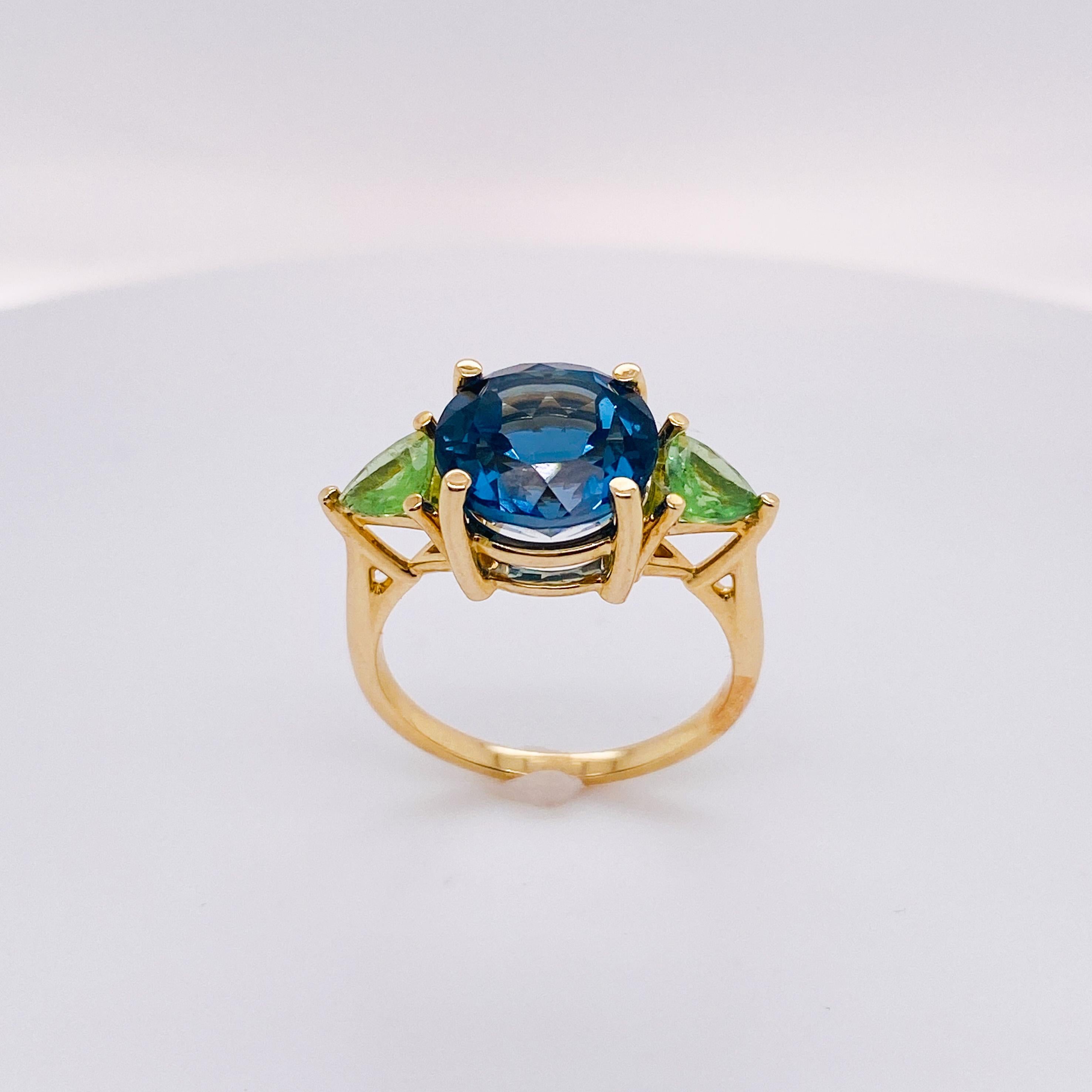 Take a walk in the ocean with these gorgeous greens and blues in this fabulous three-stone ring. Or, support your favorite NFL football team, the Seattle Seahawks!
The details for this beautiful ring are listed below:
Metal Quality: 14 karat yellow
