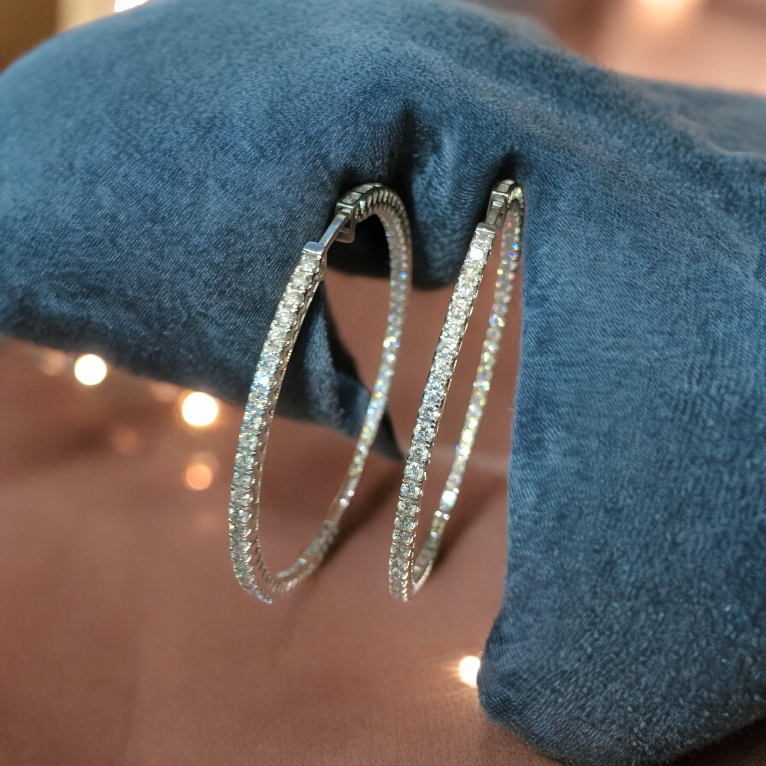 Dazzle in these stunning 4.75 carat round brilliant cut F/VS1 inside-out diamond hoop earrings, exquisitely crafted in fine 18K white gold!

Specifications :

Diamond Weight : 4.75 Carats
Diamond Shape : Round
Diamond Color Grade : F
Diamond Clarity
