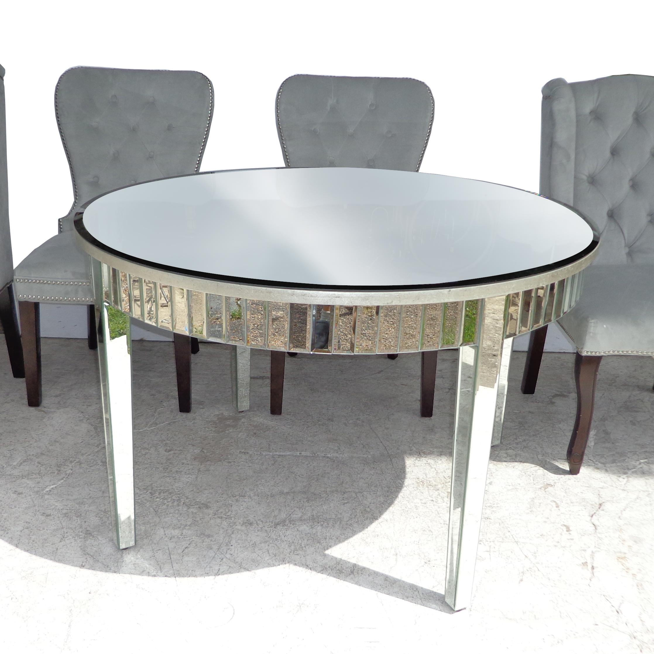 Hollywood Regency style mirrored table and chairs by Z Gallerie

Fully mirrored 47.5? dining table with 4 arm and side chairs.

Measures: Table : 47.75? Diameter x 30? Height

2 Archer dining chairs:
Wing back chairs : 23? Width x 24? Depth x