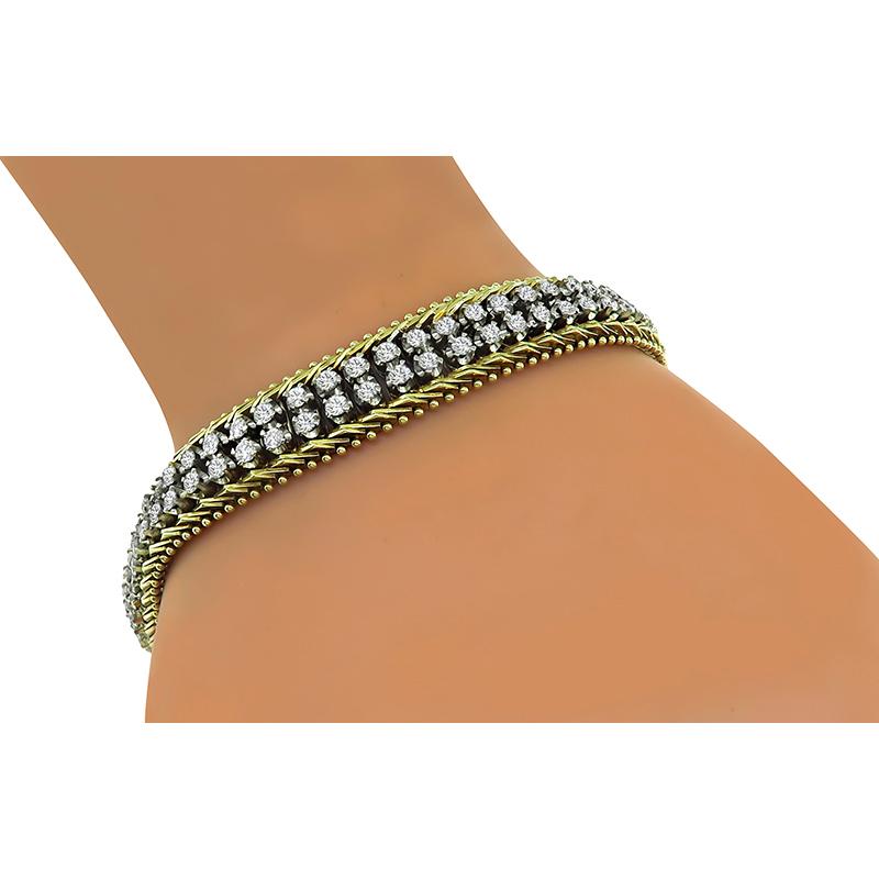 This is a gorgeous 14k yellow and white gold bracelet. The bracelet is set with sparkling round cut diamonds that weigh approximately 4.75ct. The color of these diamonds is G with VS clarity. The bracelet measures 10.5mm in width and 7 1/2 inches in