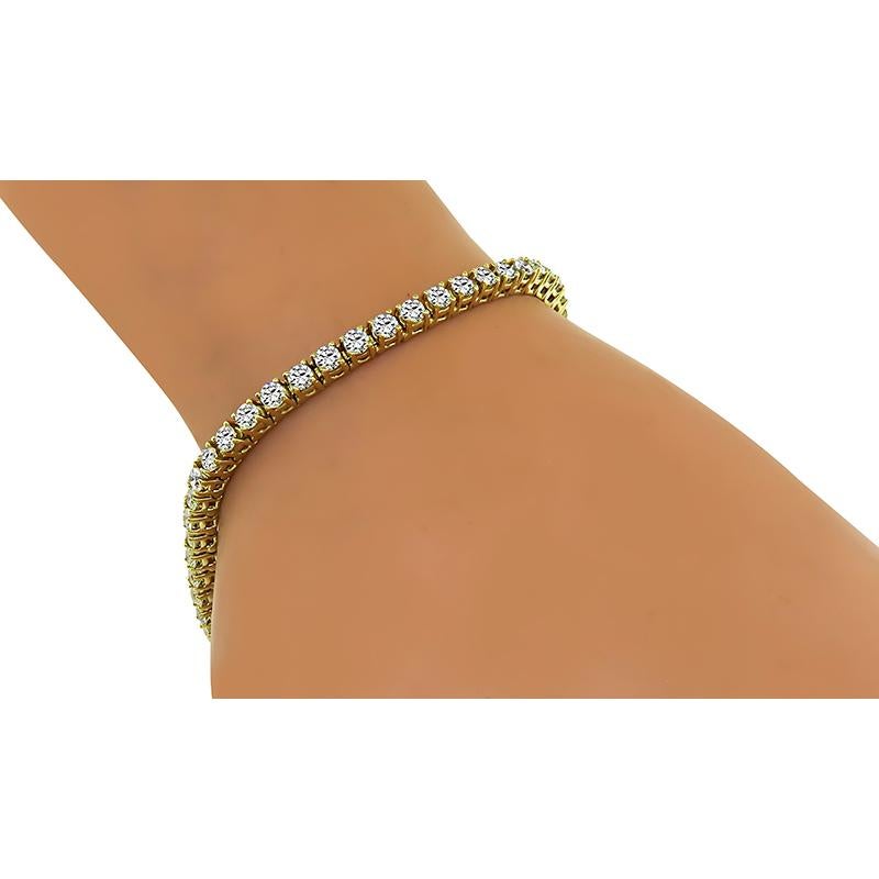 This is a charming 14k yellow gold tennis bracelet. The bracelet is set with sparkling round cut diamonds that weigh approximately 4.75ct. The color of these diamonds is H-J with VS2-SI3 clarity. The bracelet measures 7 1/4 inches in length and 3mm