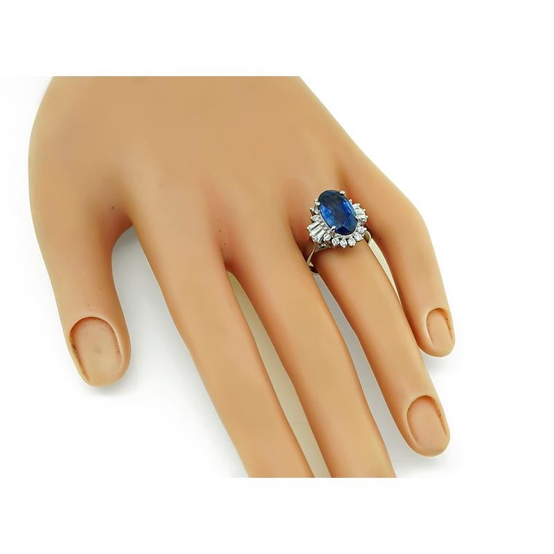 This is a gorgeous platinum ring. The ring is centered with a lovely oval cut sapphire that weighs approximately 4.75ct. The center stone is accentuated by sparkling round and baguette cut diamond accents. The top of the ring measures 16.5mm by