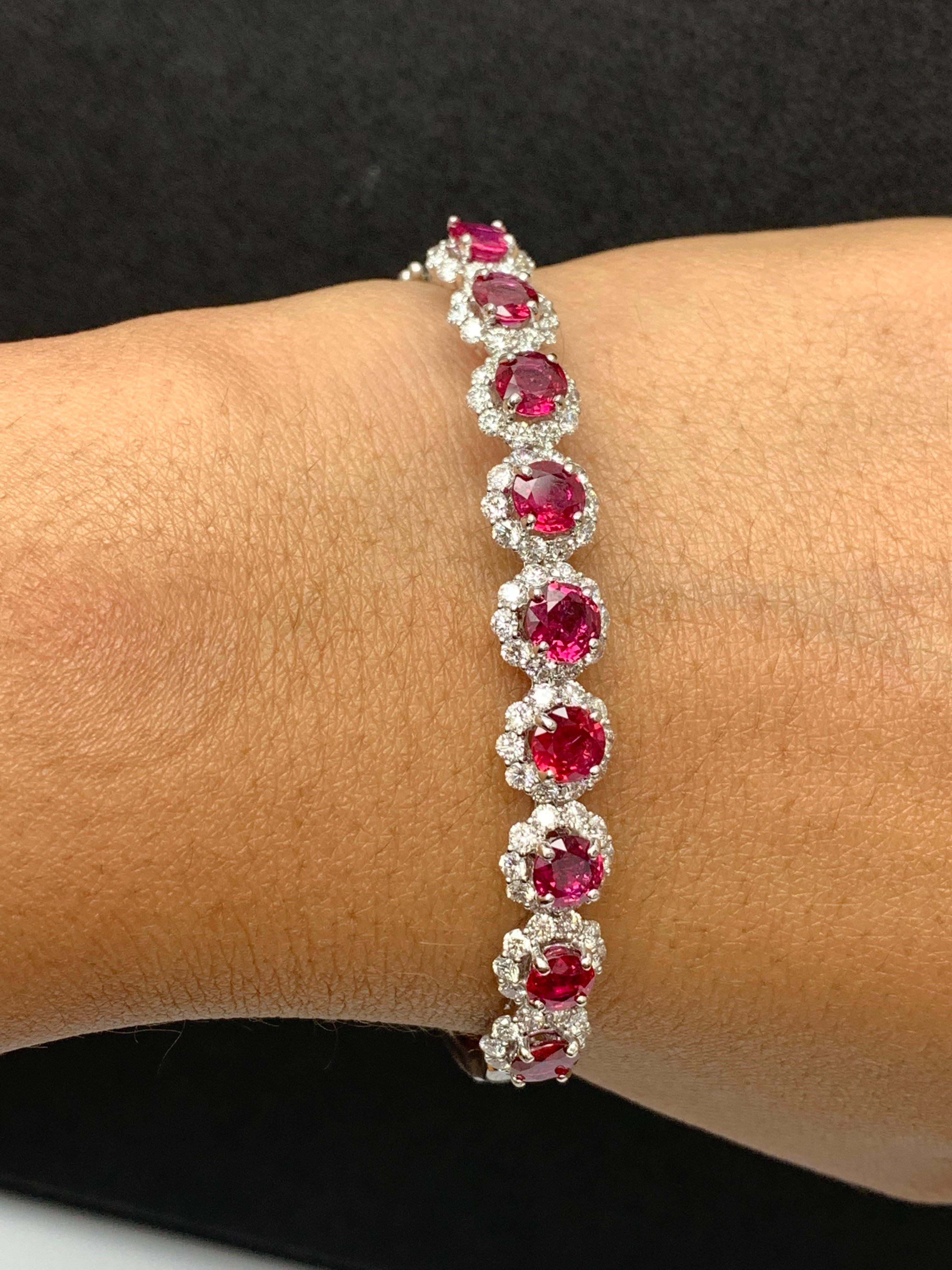 Sparkle in the spotlight with this brilliant cut ruby and diamond bangle bracelet. Features 9 brilliant-cut round rubies weighing 4.76 carats and surrounding the rubies are 90 diamonds weighing 2.45 carats elegantly set in an 18k white gold basket.